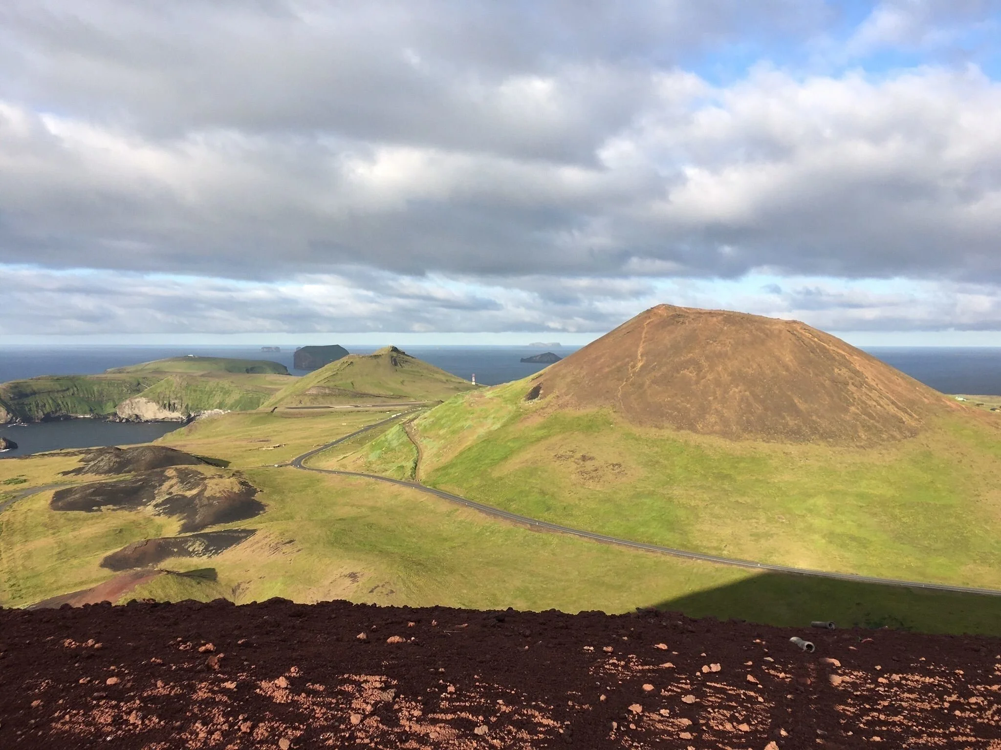 A view from Helgafell across roads, low hills, and islands near Stykkishólmur.