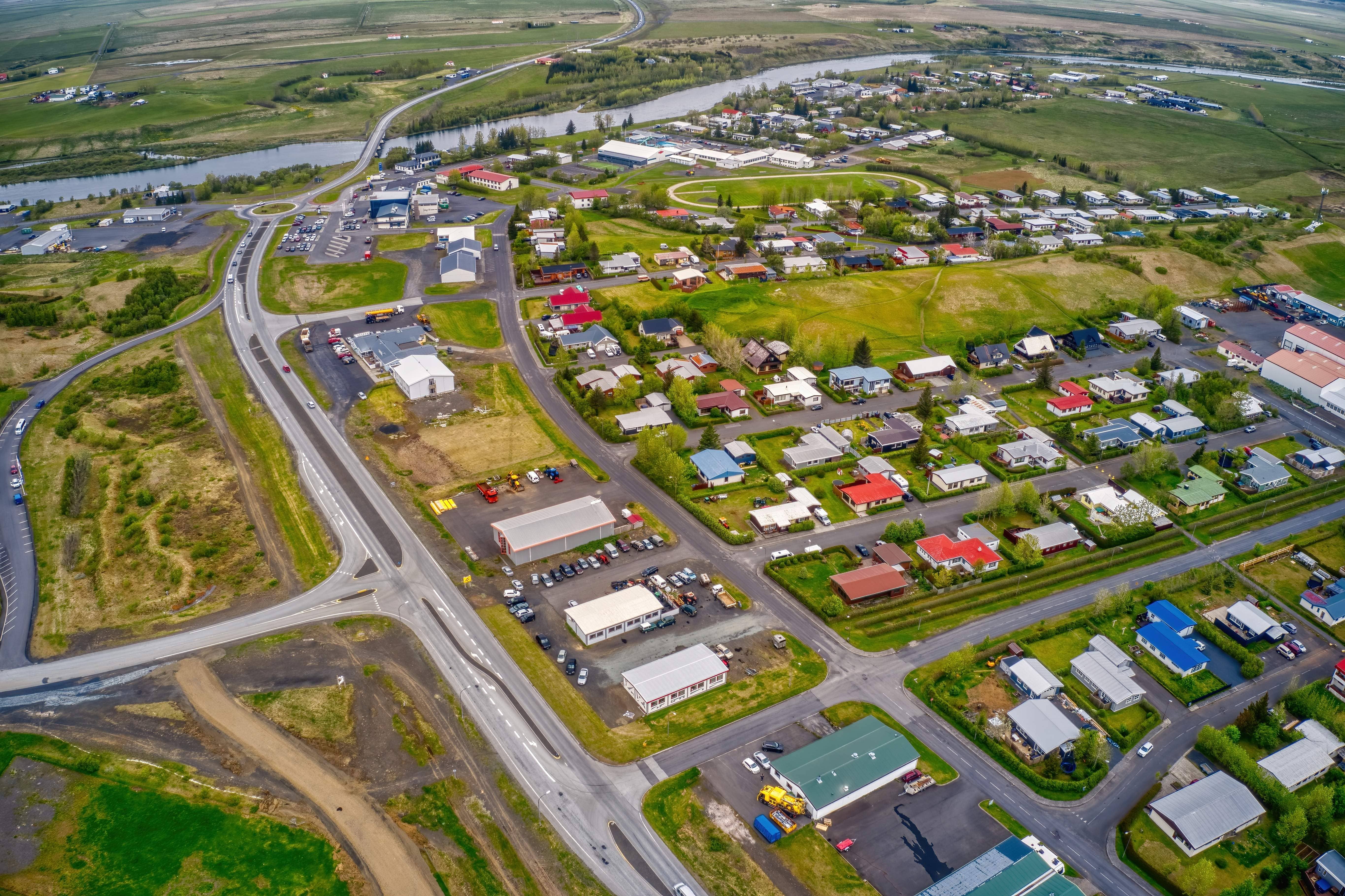 Aerial view of Hella, surrounding farmland, Ytri-Rangá, and roads in South Iceland.
