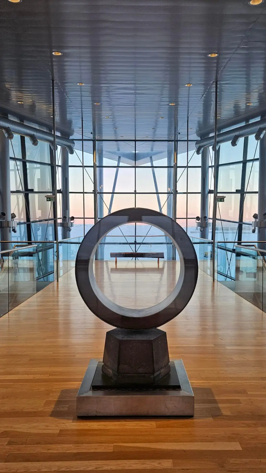 Circular art installation inside the glass-walled Geothermal Exhibition at Hellisheiði.
