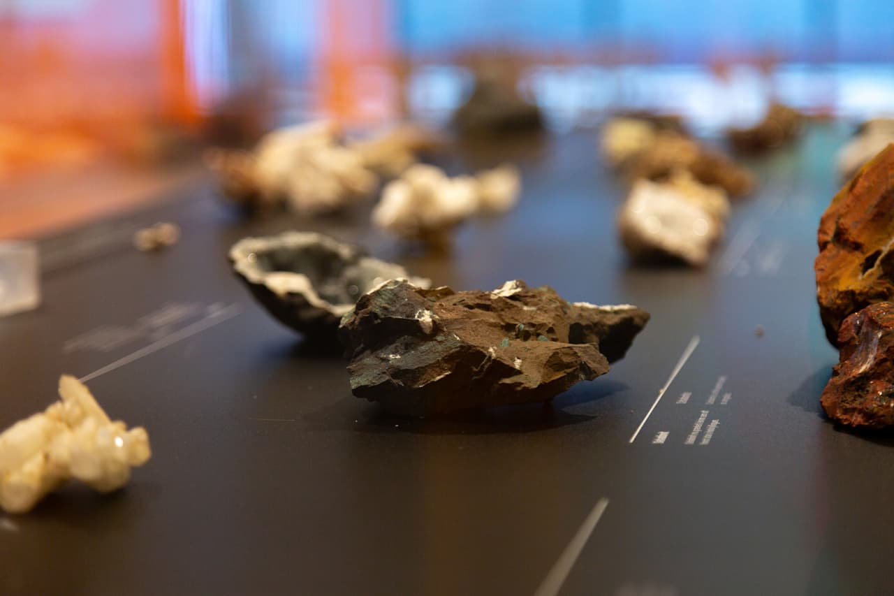 Close-up of Icelandic rock and mineral samples displayed inside Hellisheiði Geothermal Exhibition.