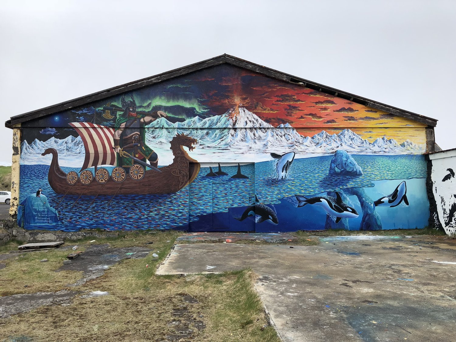 Large Viking ship and glacier mural painted on an old building in Hellissandur.