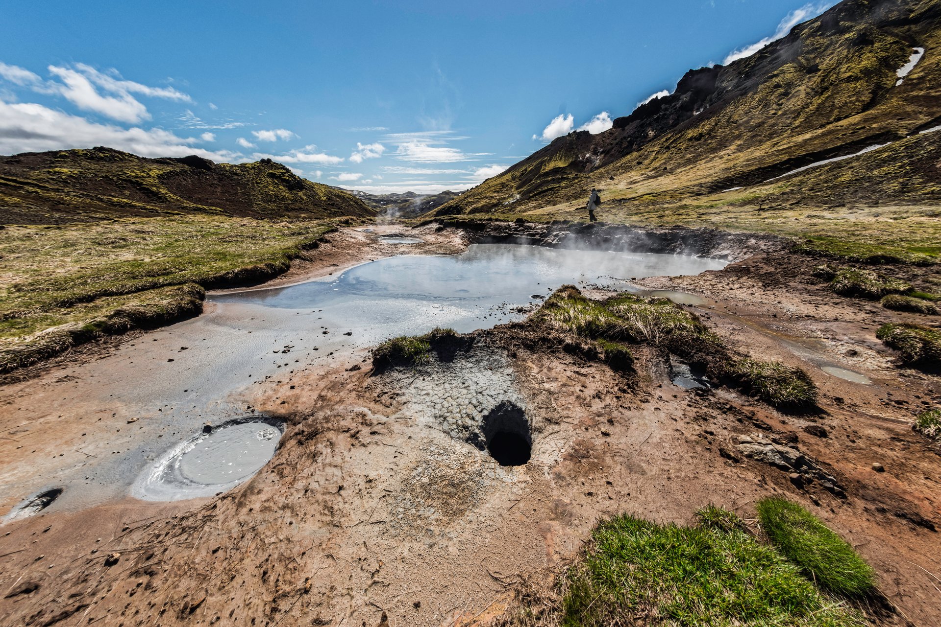 Steam rising from geothermal pools beside a marked Hengill walking route.