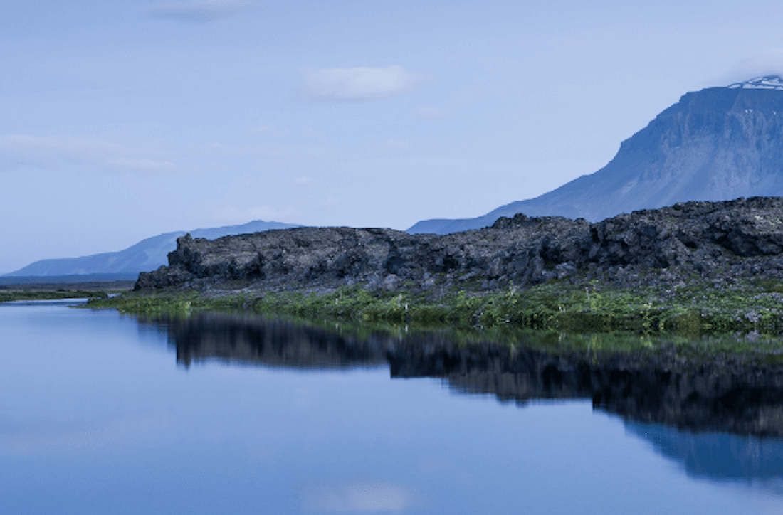 Lava rocks, river water, and the slope of Herðubreið near Herðubreiðarlindir.