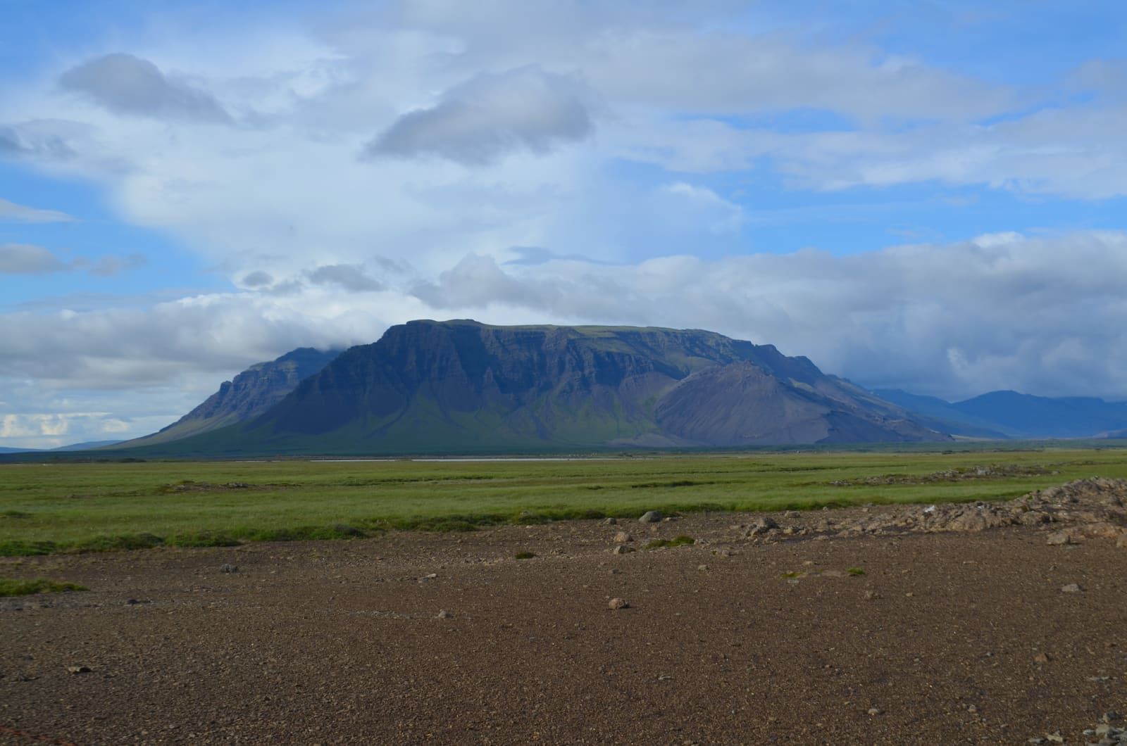 Fagraskógarfjall rising above the green floor of Hítardalur in West Iceland.