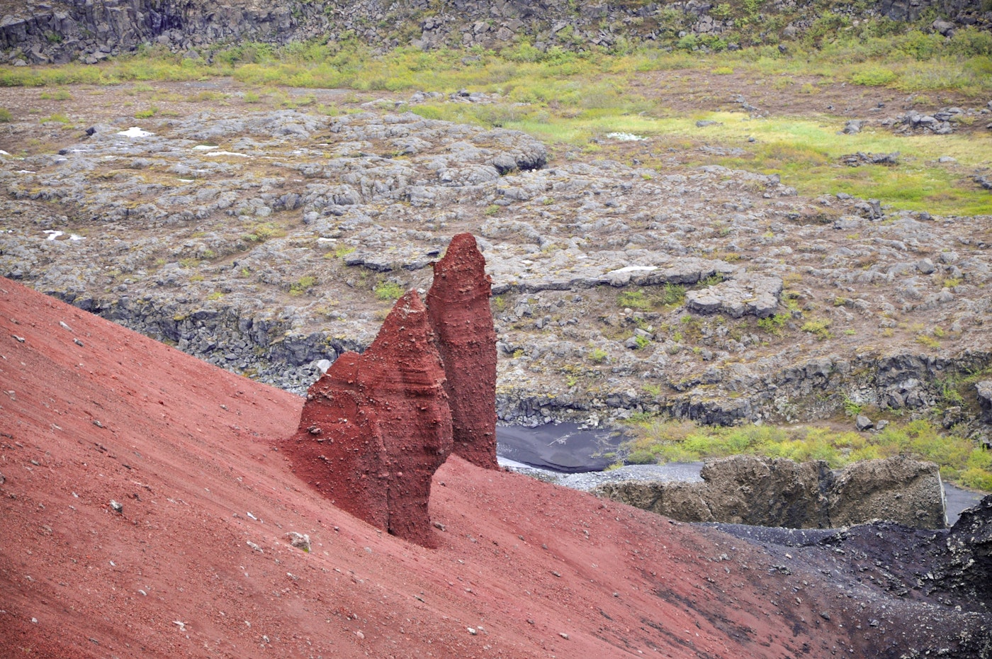 Red Rauðhólar slopes above the volcanic ground near Hljóðaklettar.