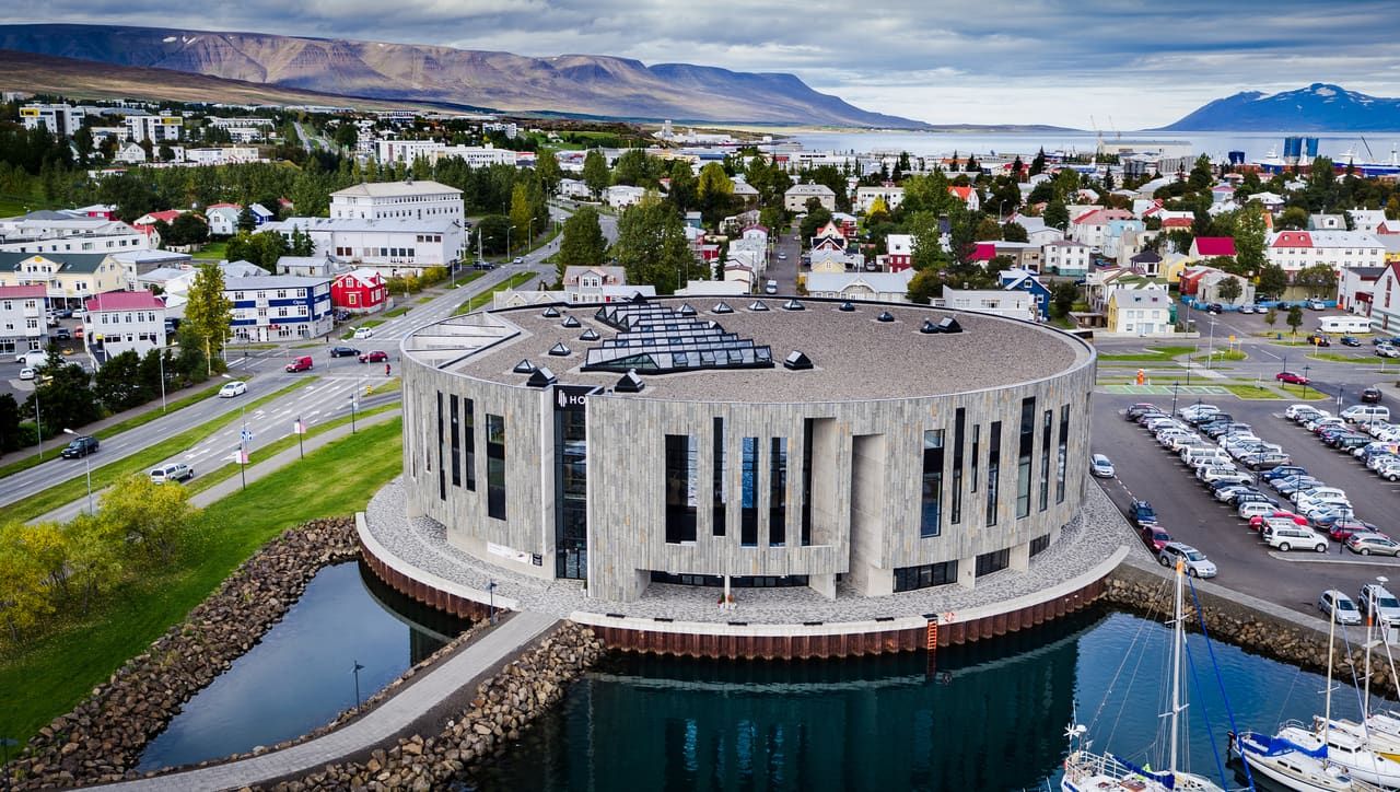 Hof Cultural and Conference Centre beside the harbor in Akureyri with Eyjafjörður and the town behind it.