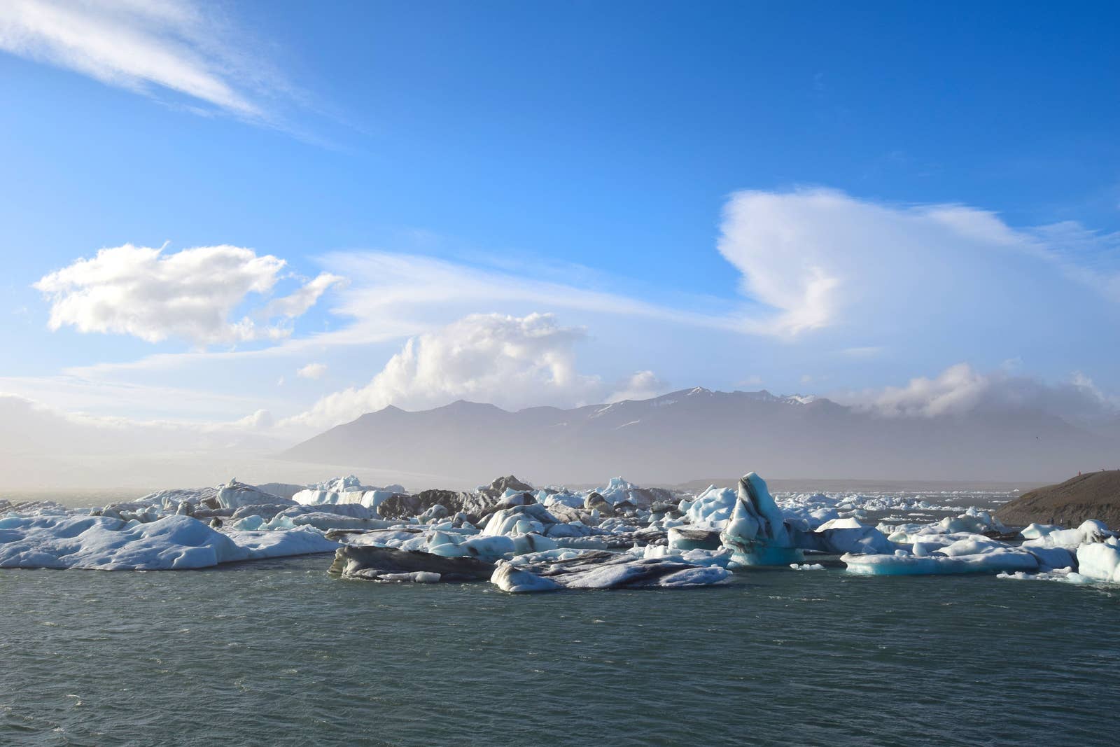 The broad white Hofsjökull ice cap seen above dark volcanic Highlands terrain.