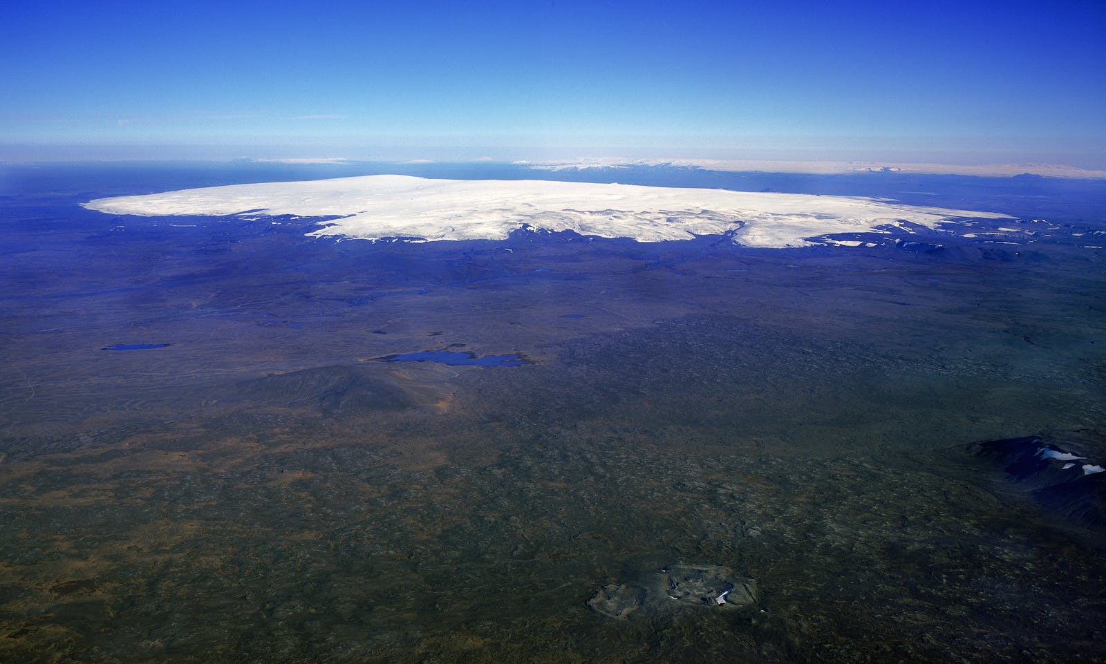 Hofsjökull ice cap rising above snowy central Highlands terrain in Iceland.