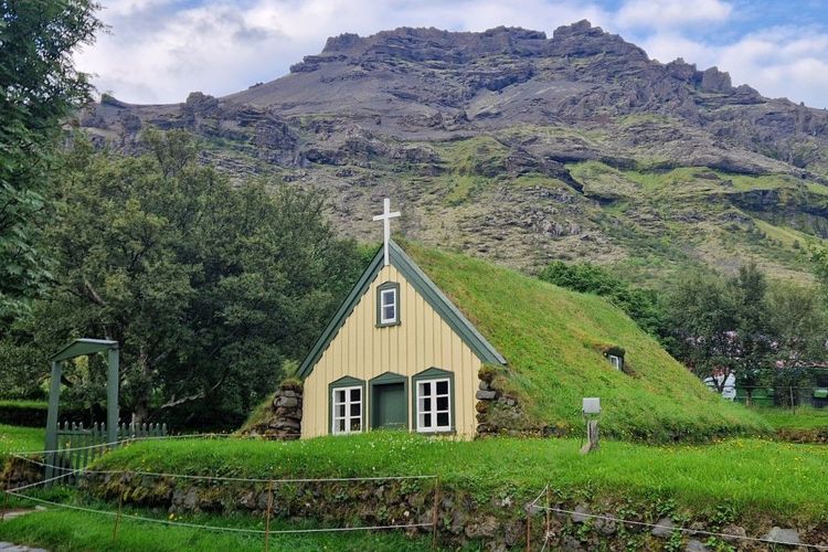 Front view of Hofskirkja Turf Church and its grass-covered side walls in Öræfi.