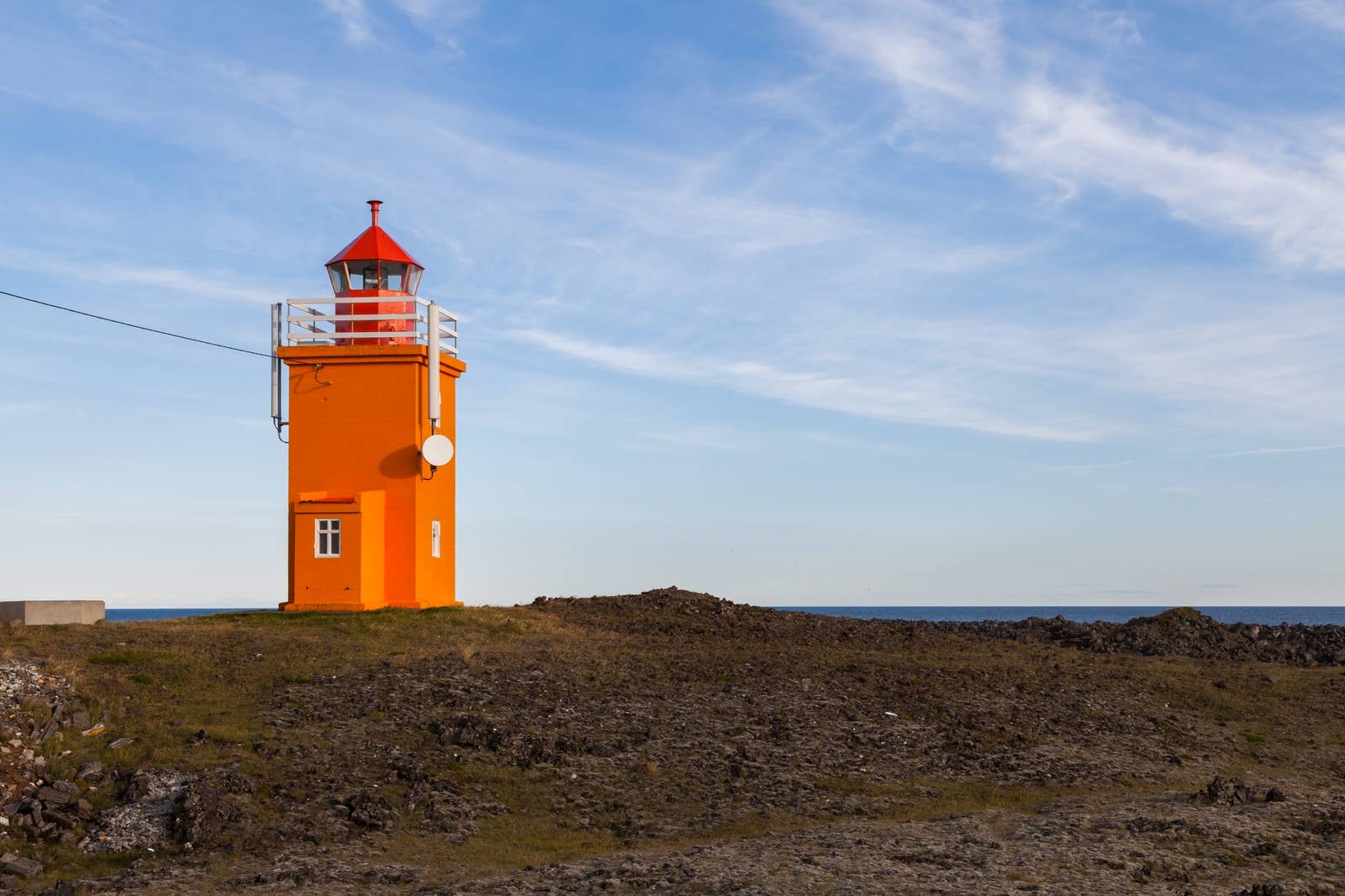 Hópsnesviti lighthouse above low lava and the sea near Grindavík.