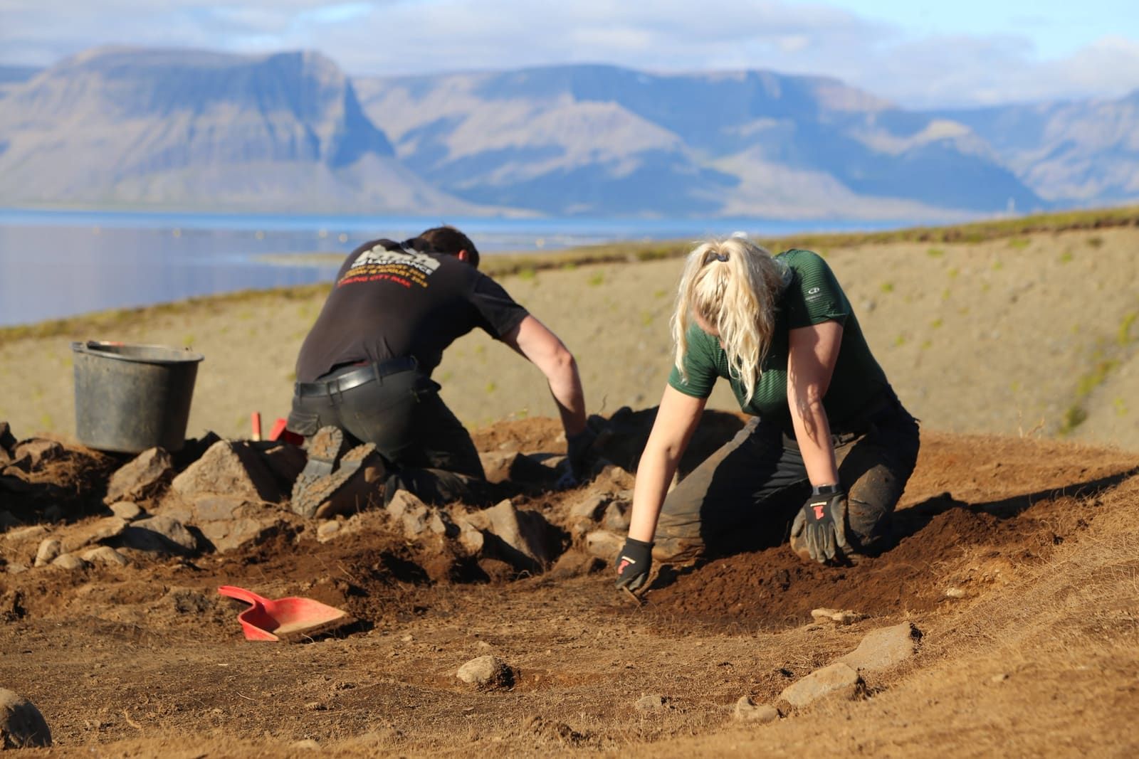 Archaeology work near Hrafnseyri with Arnarfjörður and Westfjords mountains in the distance.