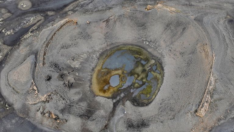 Aerial view into the circular interior of Hrossaborg crater.