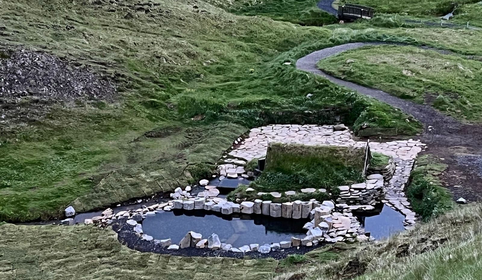 The stone-lined pools and grassy path at Hrunalaug near Flúðir.