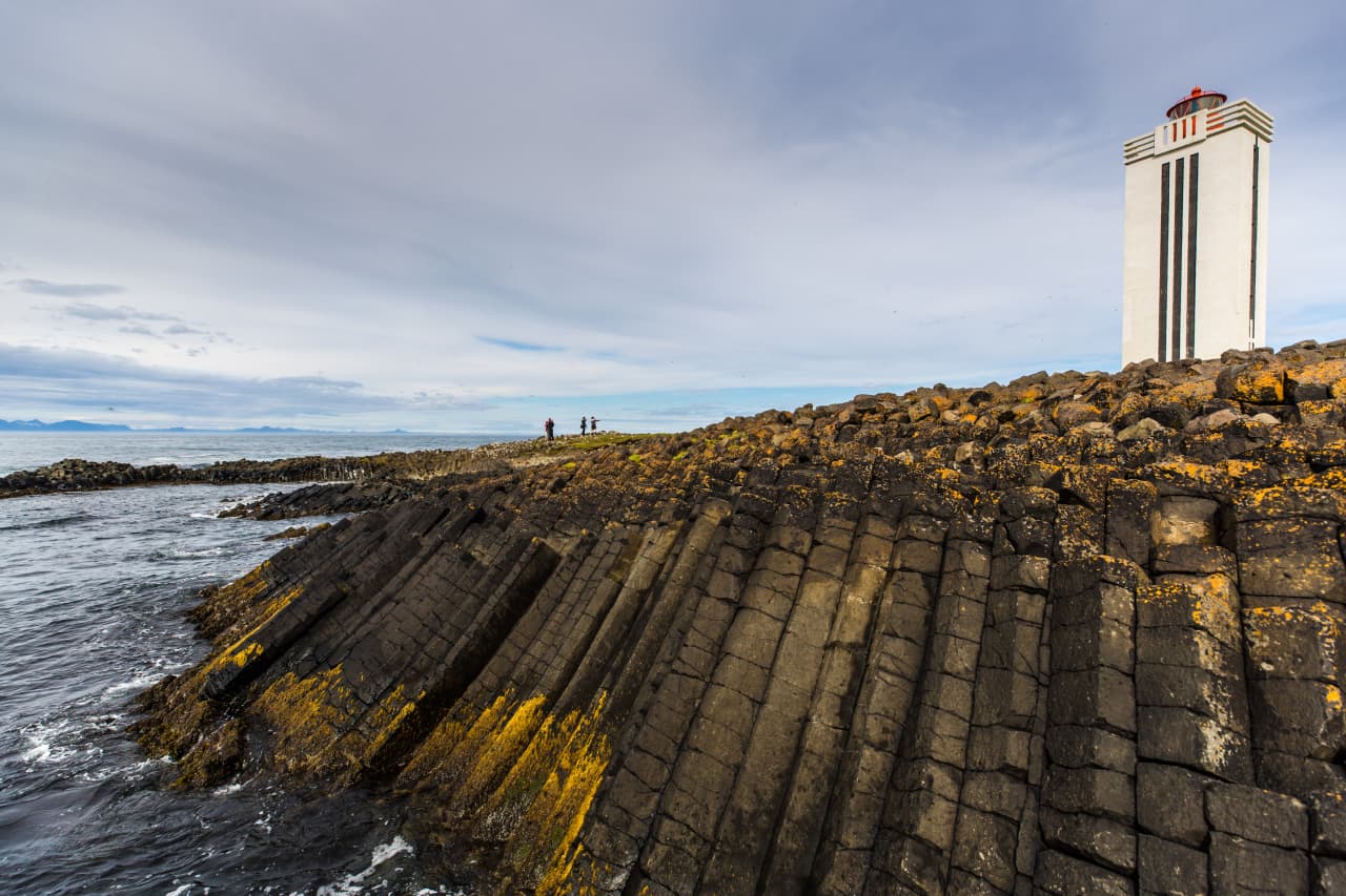 Basalt shore and lighthouse at Kálfshamarsvík on the Húnaflói coast.