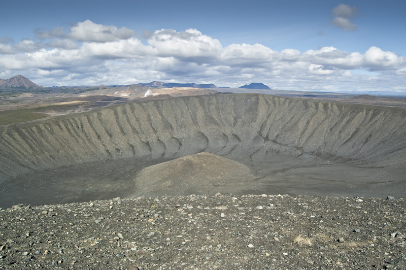 Snow patches and dark volcanic slopes inside the Hverfell crater bowl.