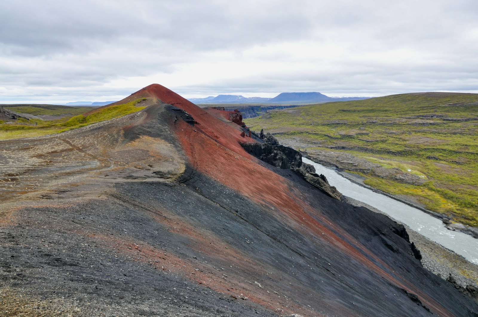 Red and black Rauðhólar hills above the Jökulsá á Fjöllum river in Jökulsárgljúfur.