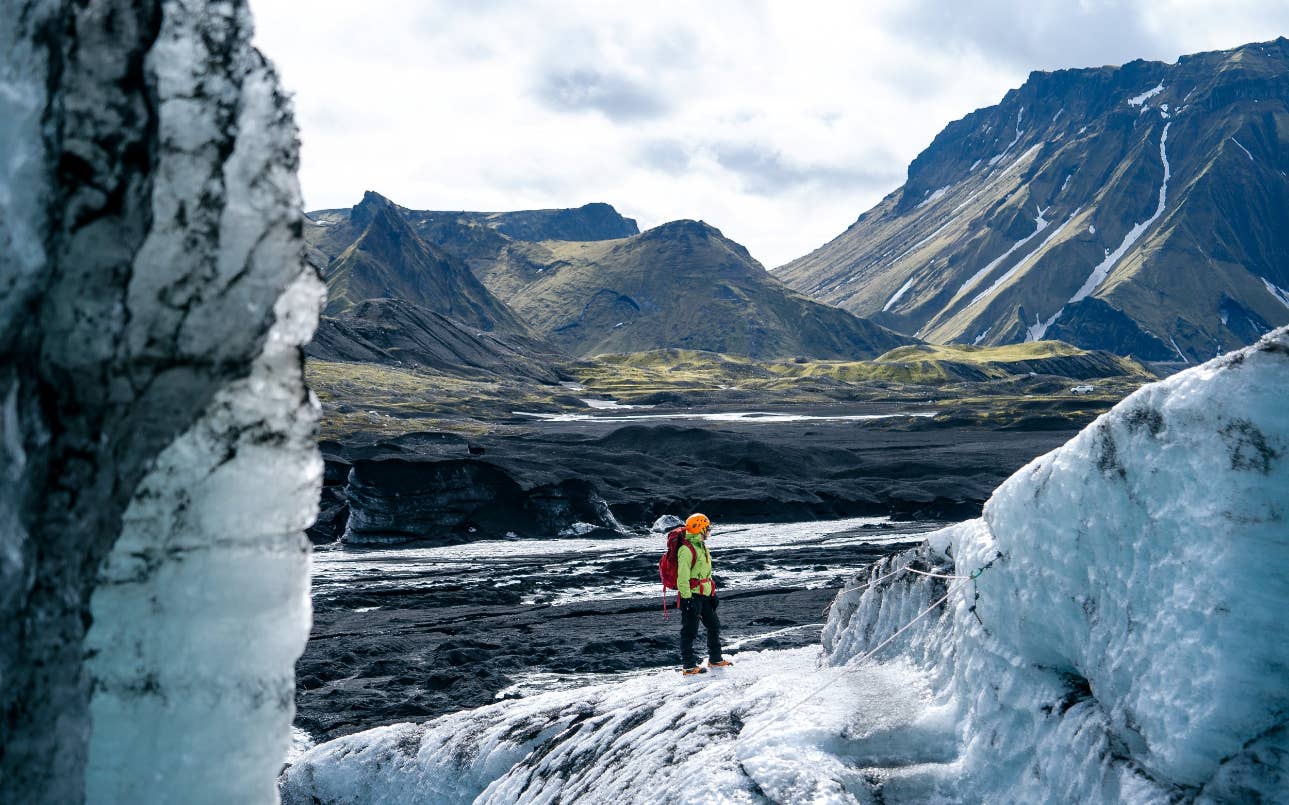 A traveler with glacier gear standing on Mýrdalsjökull near the Katla volcanic system.