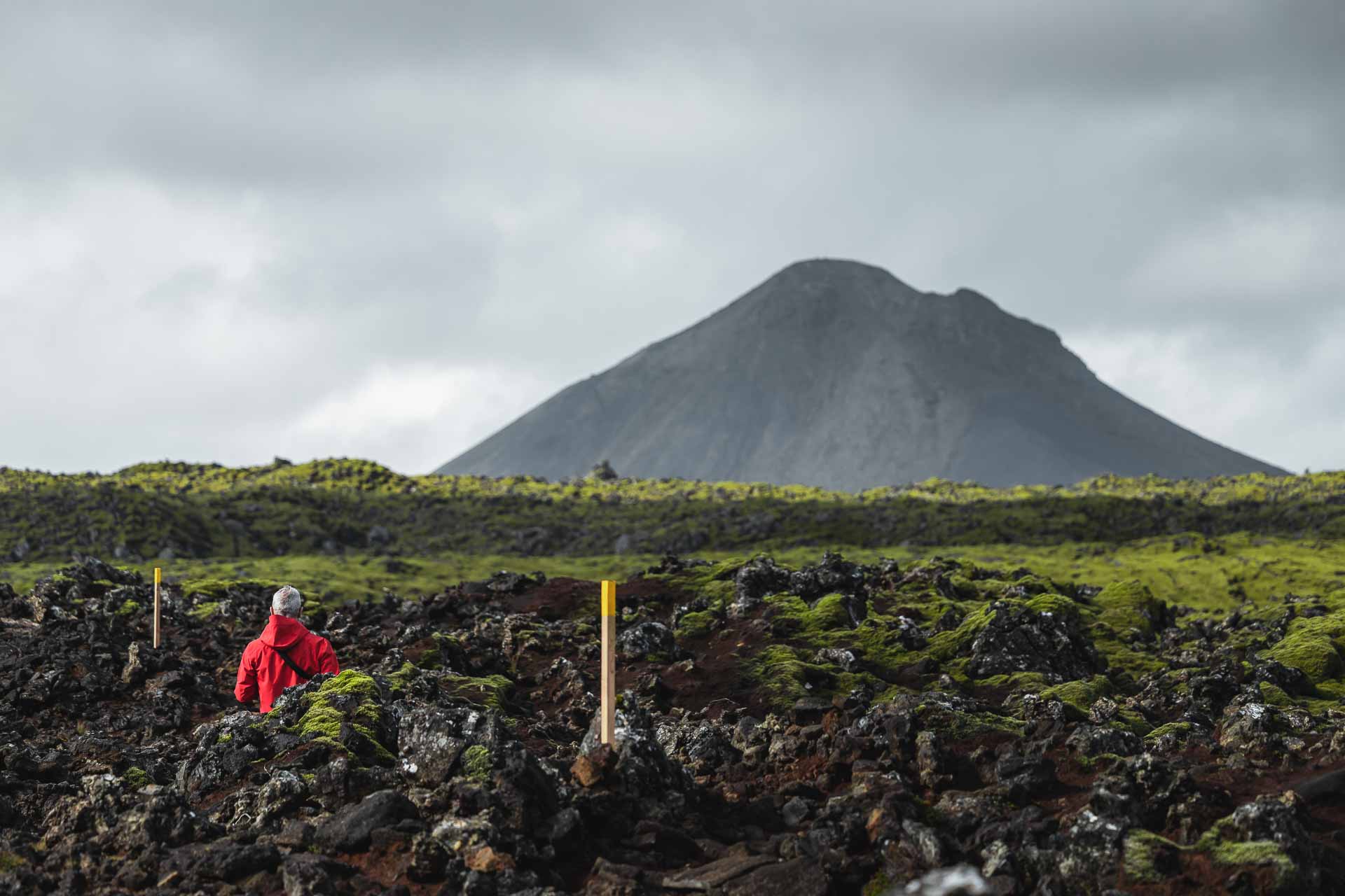 Marked trail posts across rough lava on the approach to Keilir mountain.