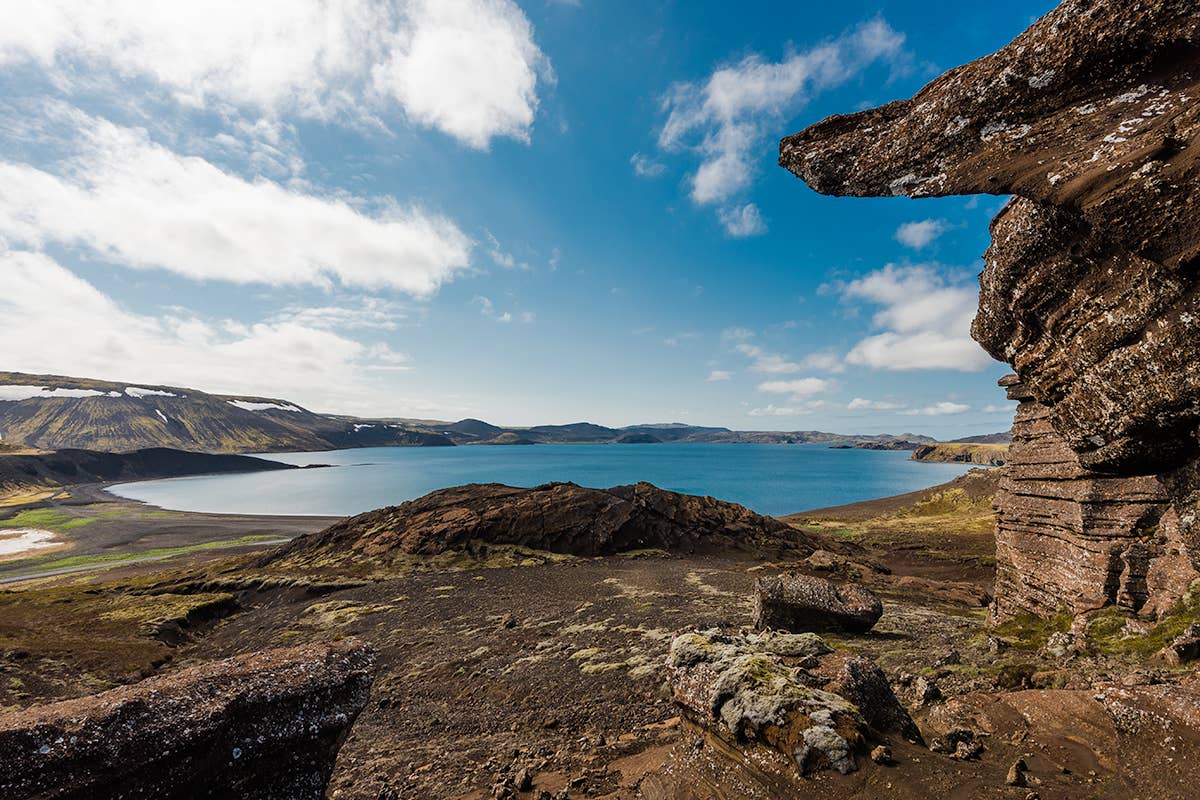 Wide view across Kleifarvatn with dark shore and Reykjanes hills beyond the water.