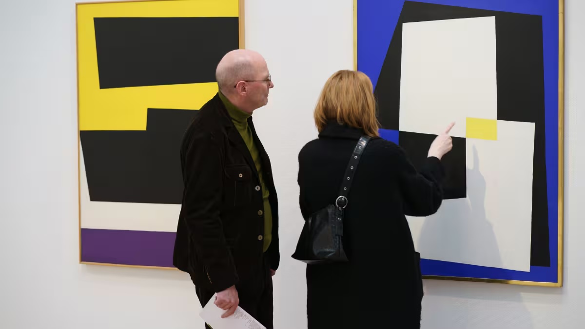 Visitors looking at modern artwork inside Gerðarsafn in Kópavogur.