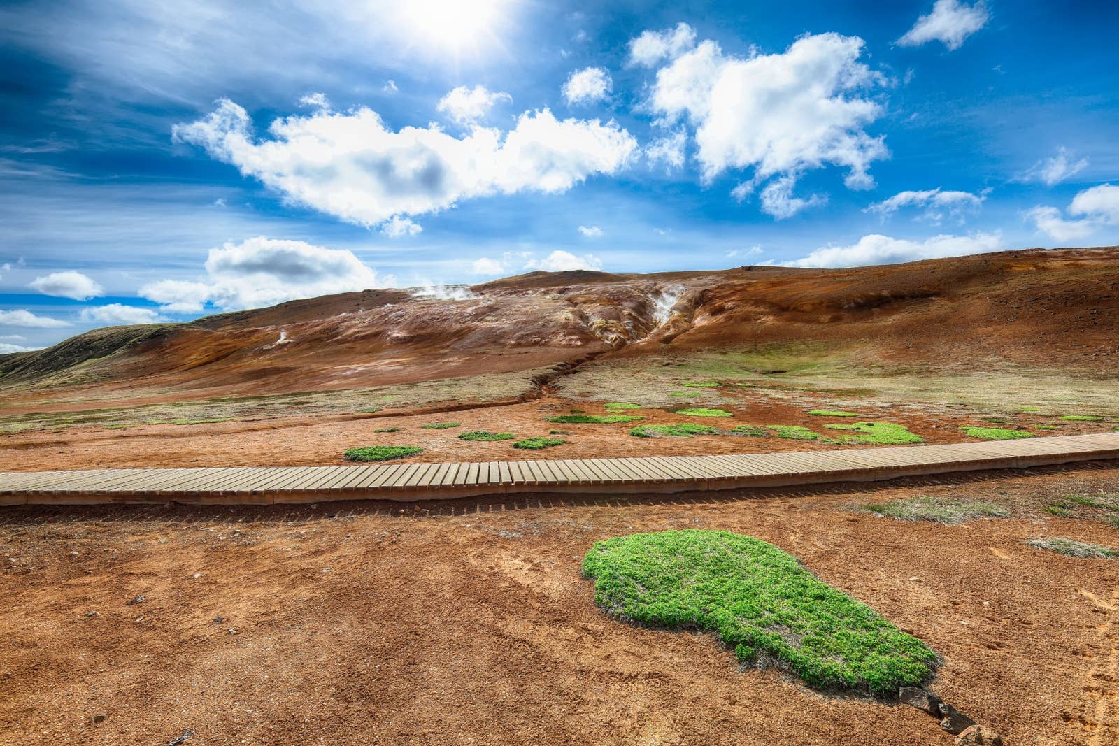 Wooden planks crossing geothermal ground in the Leirhnjúkur area near Krafla.