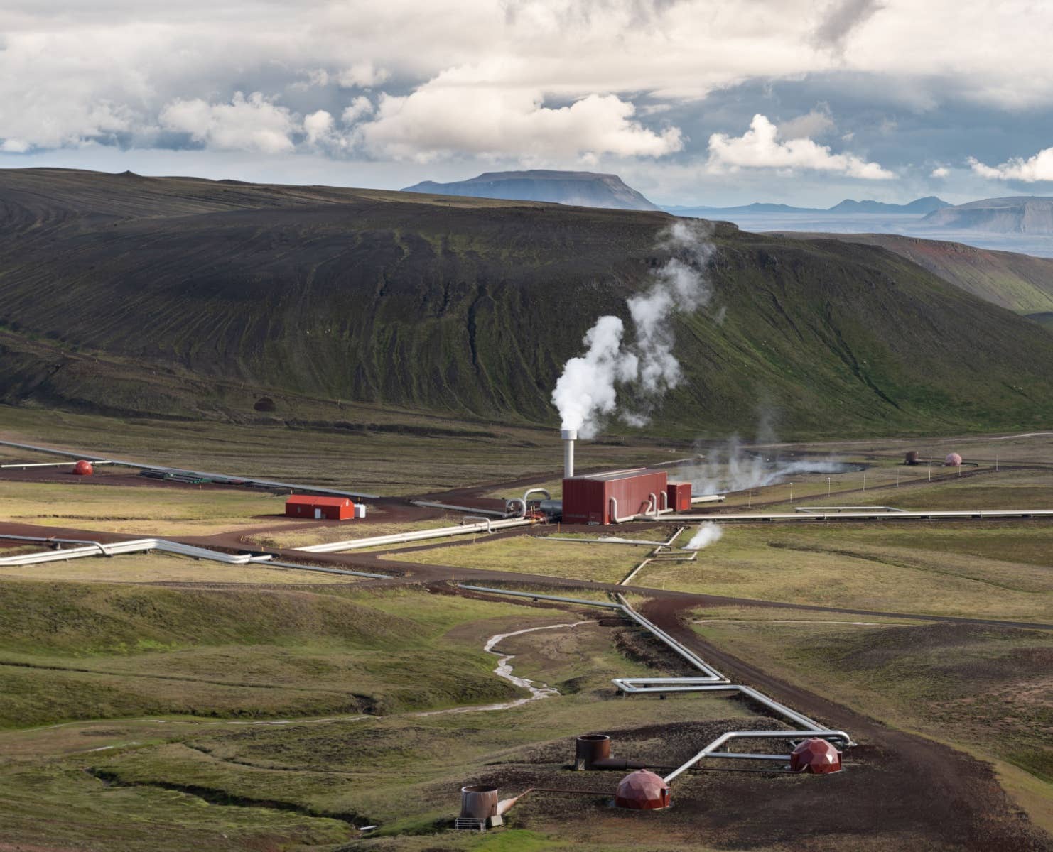 Krafla geothermal power station surrounded by volcanic hills in North Iceland.