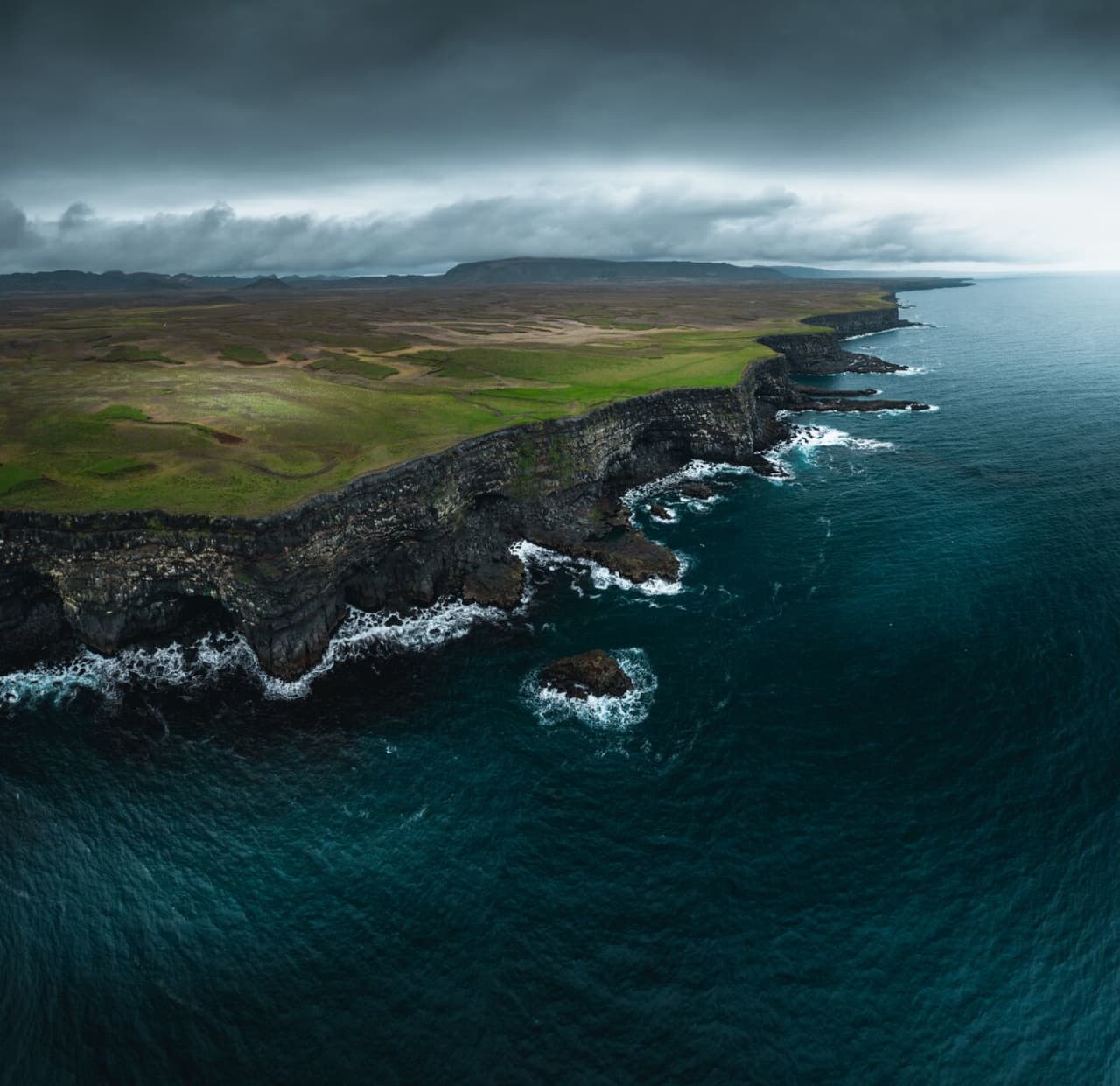 Aerial view of Krýsuvíkurbjarg sea cliffs and rough southern Reykjanes coastline.