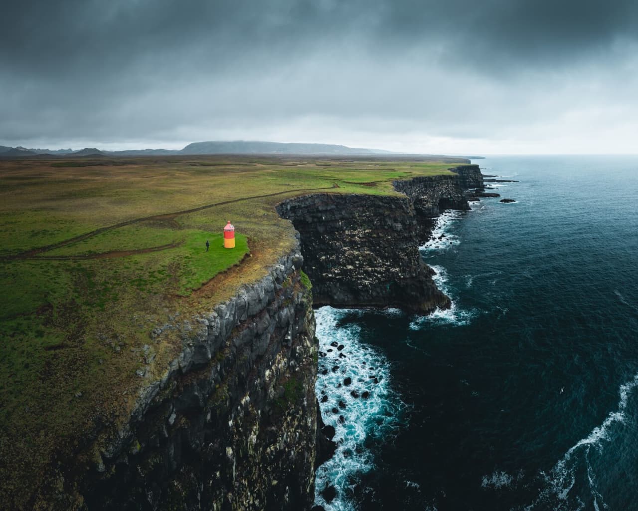 Krýsuvíkurbjarg marker beside open grassy clifftop ground on Reykjanes.