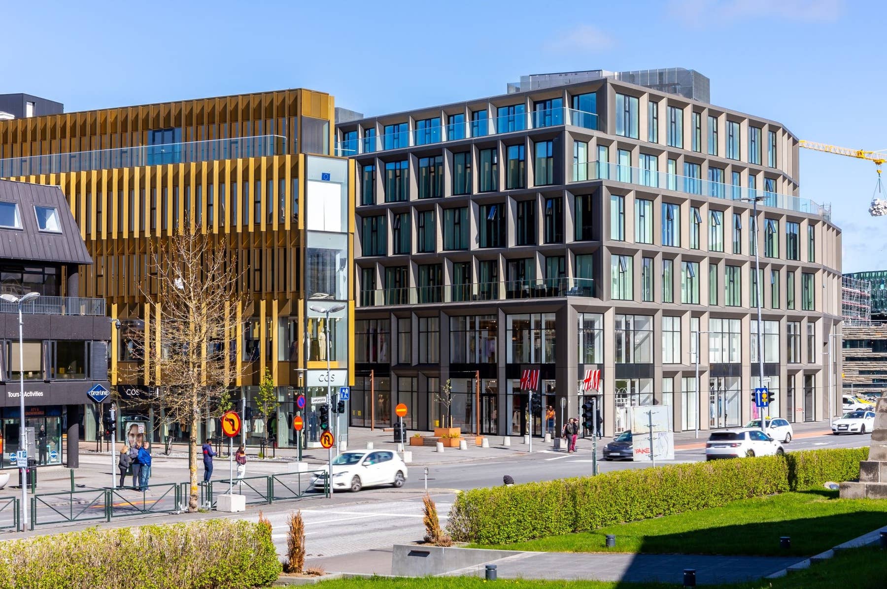 Modern buildings and traffic along Lækjargata near central Reykjavík.