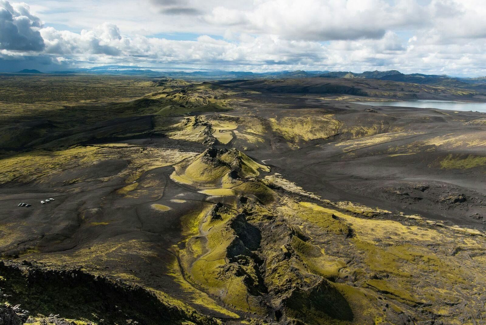 Ground-level view across mossy Lakagígar craters and black volcanic terrain in Vatnajökull National Park.