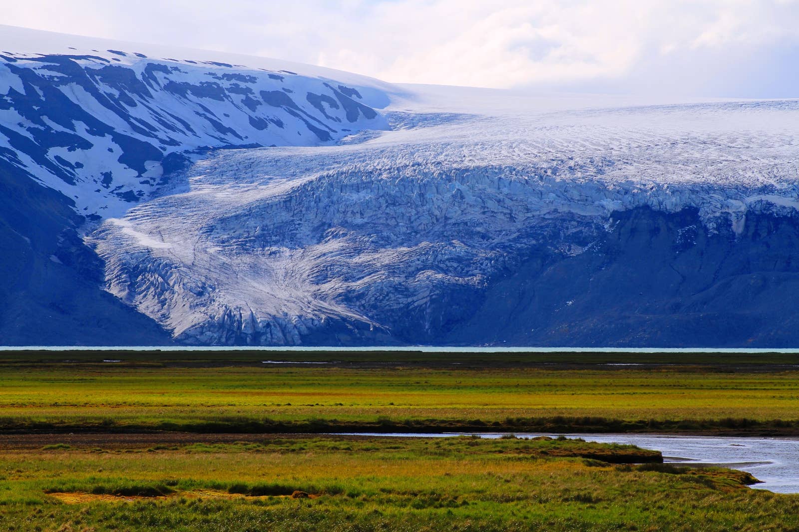 Langjökull glacier edge above dark highland ground in west Iceland.