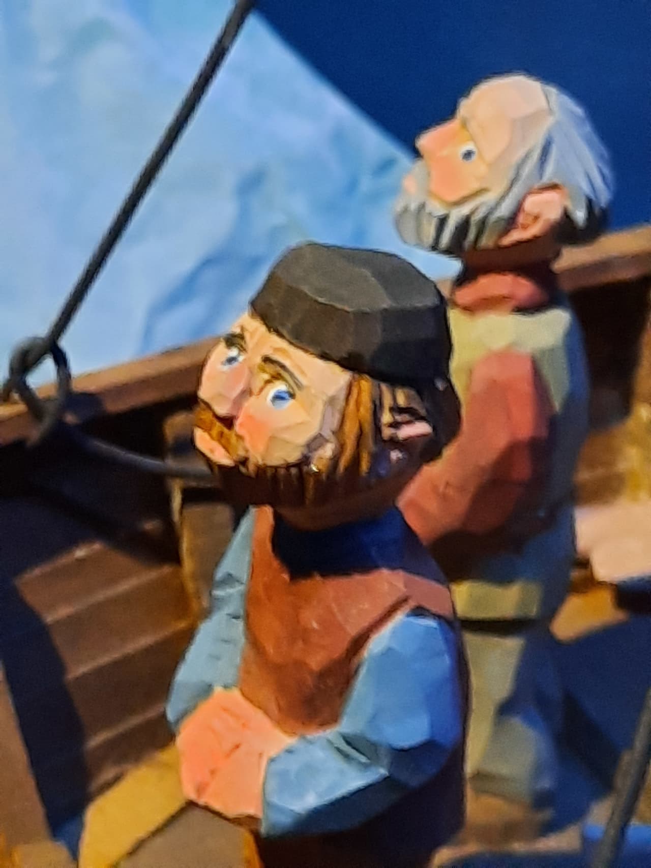 Close view of carved wooden figures in the Leifsbúð exhibition.