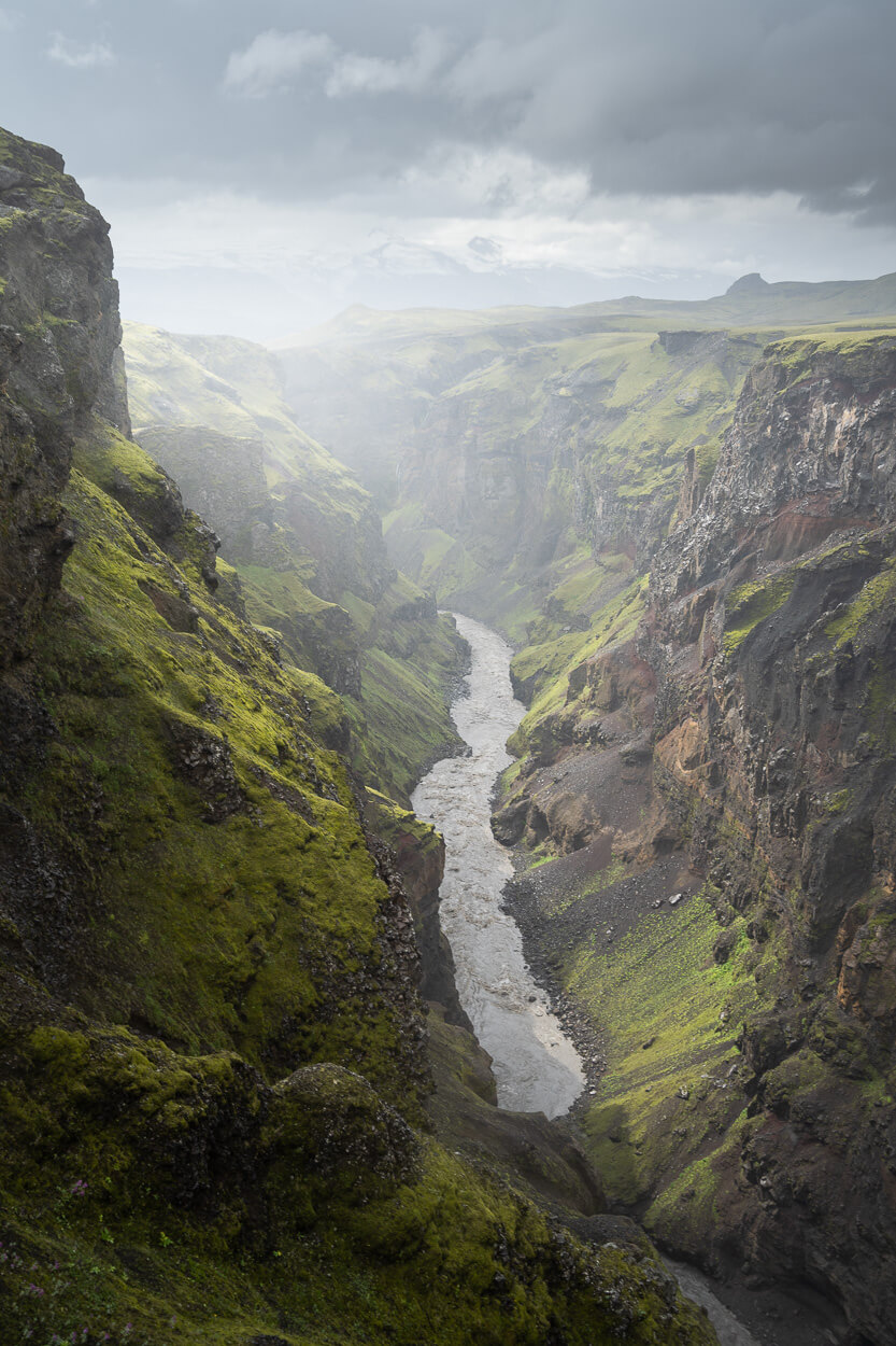 The Markarfljót river running through the deep green walls of Markarfljótsgljúfur canyon.