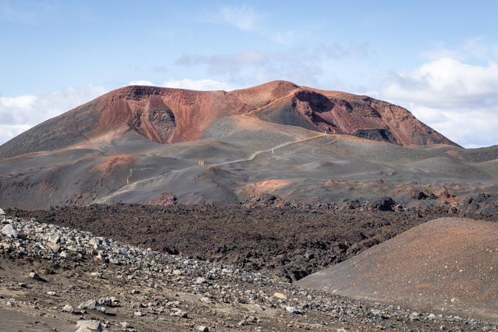 Red and black Móði and Magni craters rising above young lava on Fimmvörðuháls.