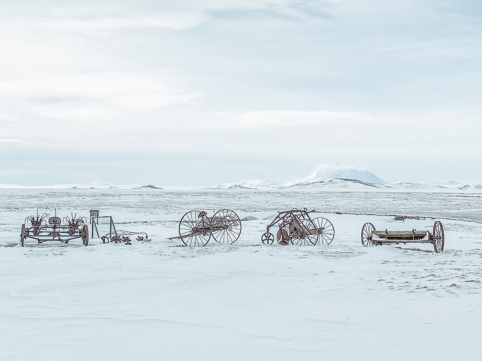 Old farm equipment on the snowy plain near Möðrudalur in Northeast Iceland.