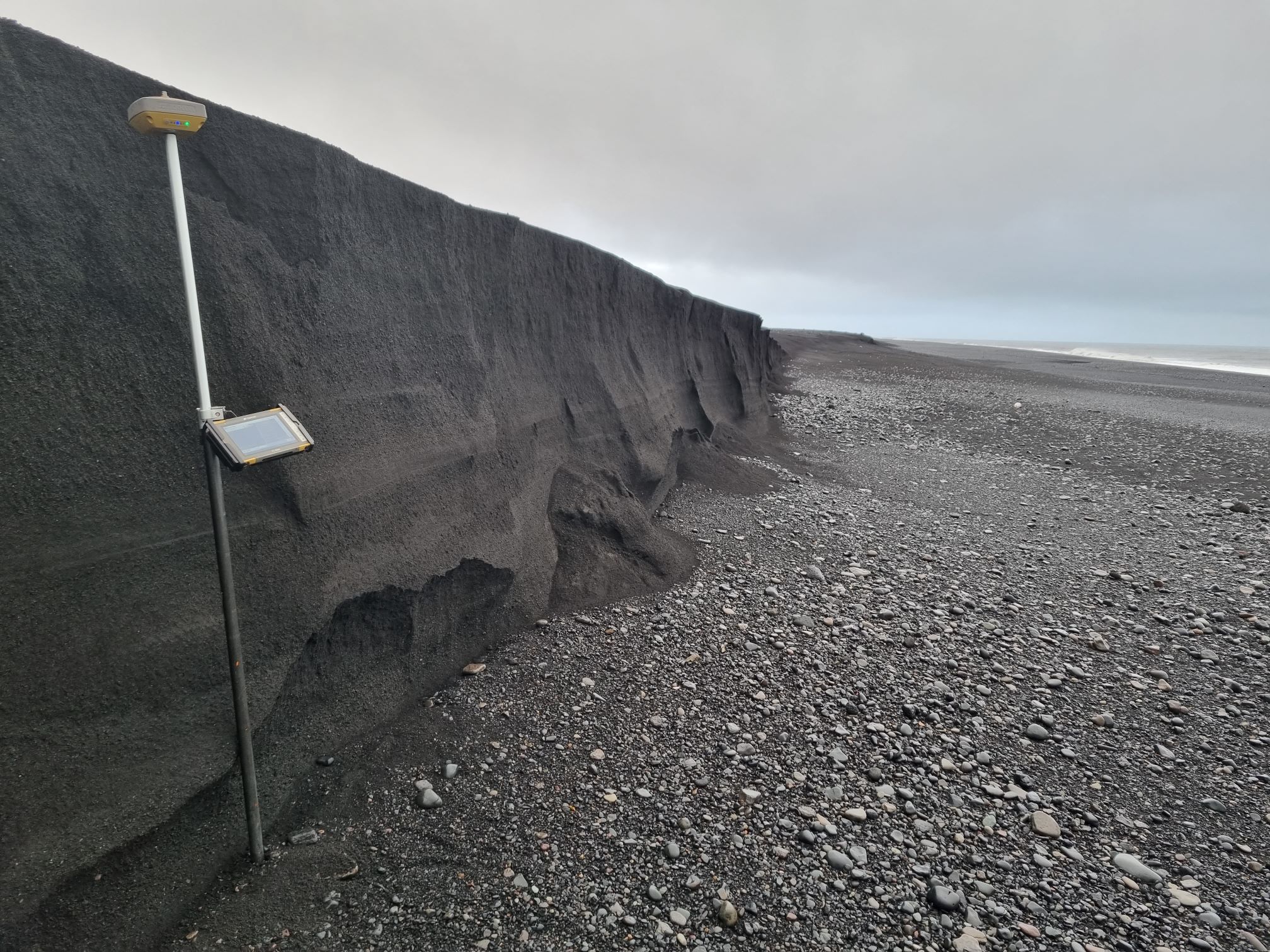 Dark Mýrdalssandur storm and flood deposits exposed beside the South Coast shoreline.