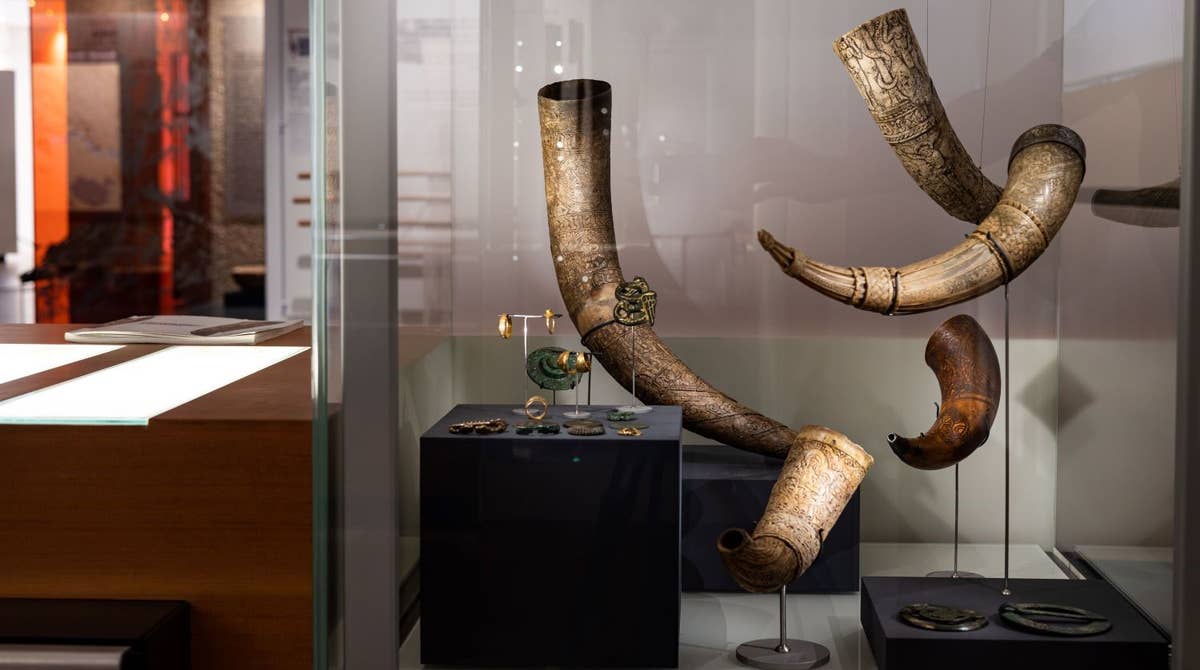 Decorated drinking horns displayed in a glass case at the National Museum of Iceland.