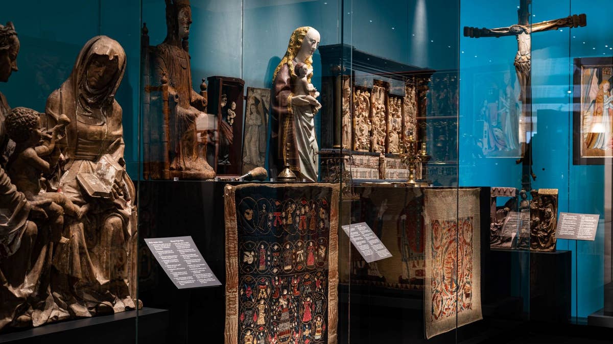 Religious sculptures, textiles, and carved artifacts displayed at the National Museum of Iceland.