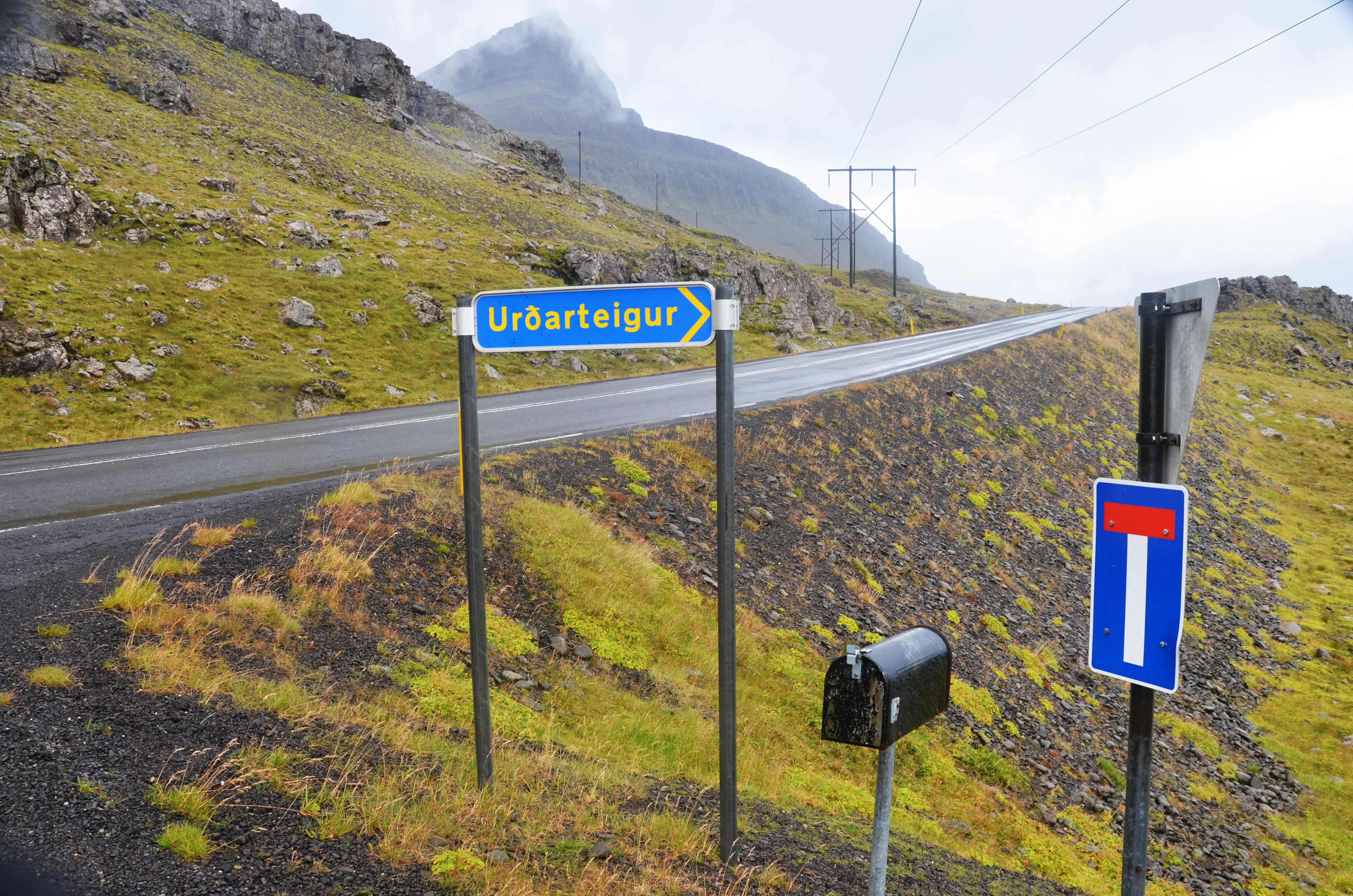 Residential street and mountain backdrop in Neskaupstaður.