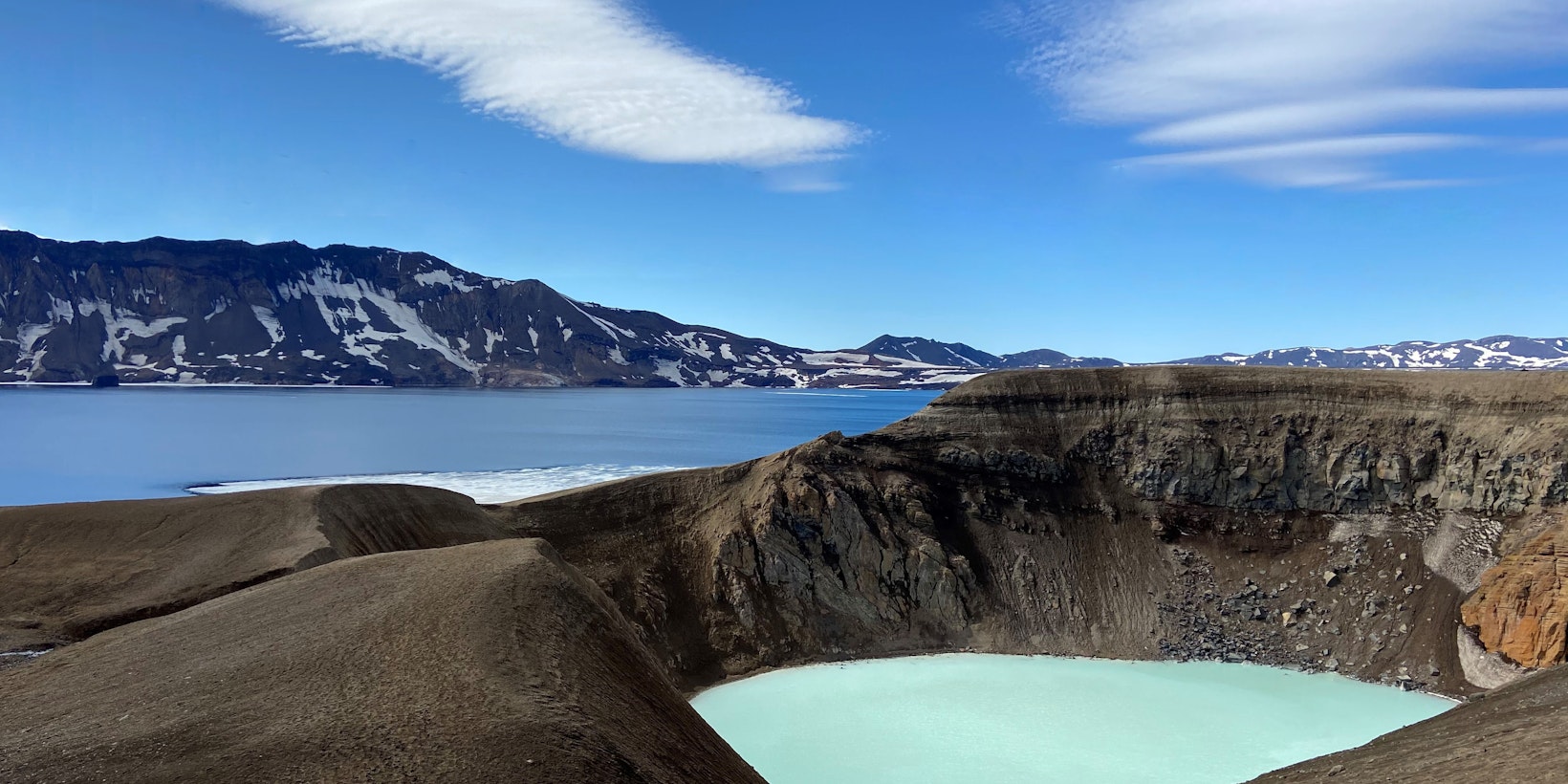 Víti crater and Öskjuvatn lake at Askja with snow-streaked highland mountains beyond Ódáðahraun.
