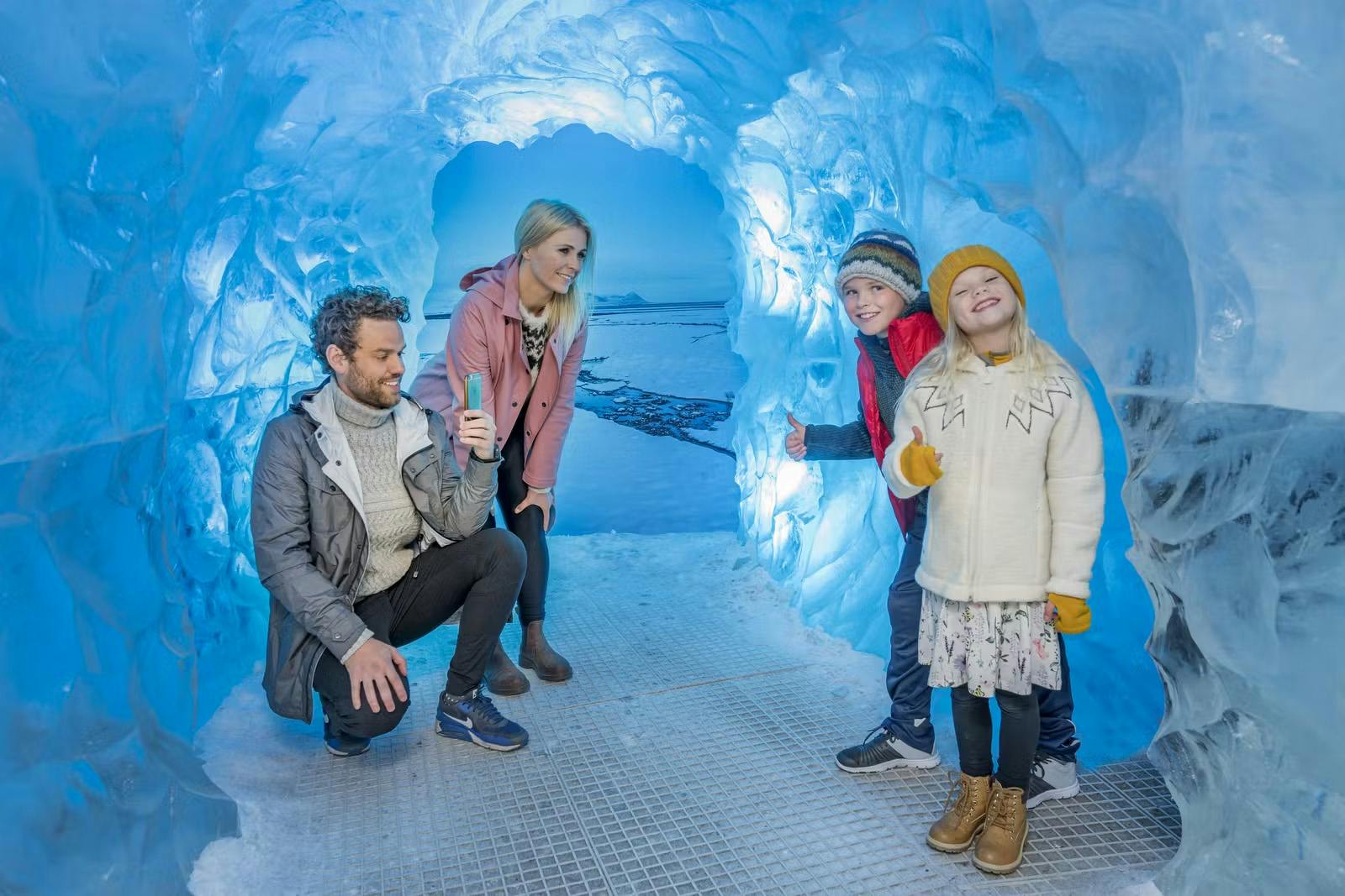 Blue-lit indoor ice cave passage inside Perlan in Reykjavík.