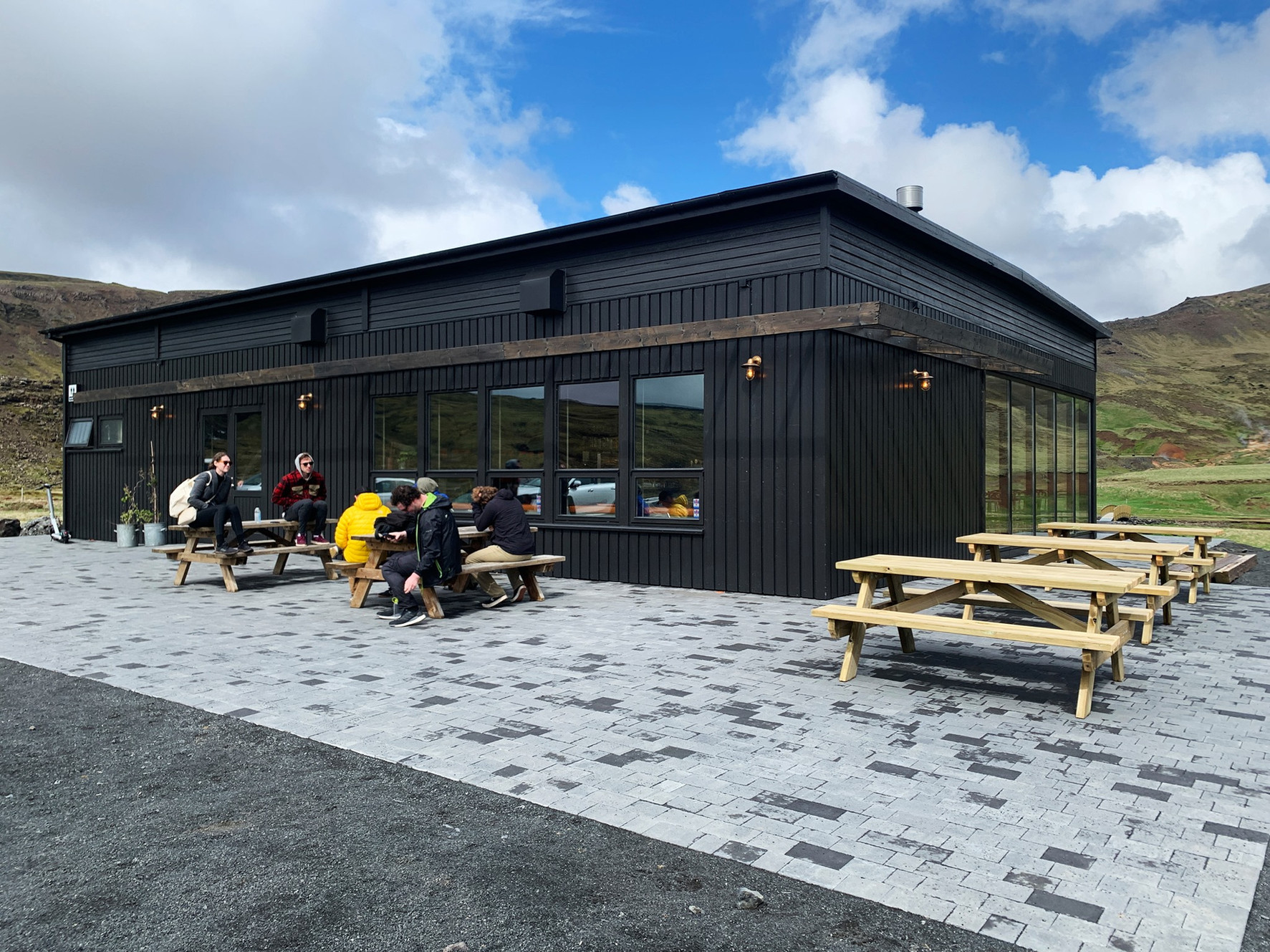 Visitor building and outdoor seating at the Reykjadalur valley trail area near Hveragerði.