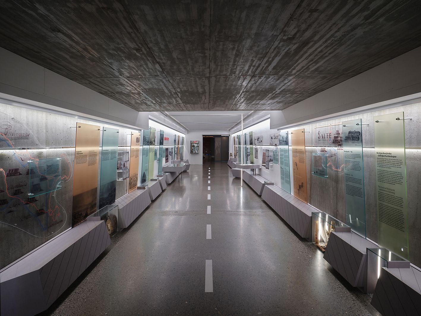 Bright corridor exhibition inside Aðalstræti showing Reykjavík history displays.