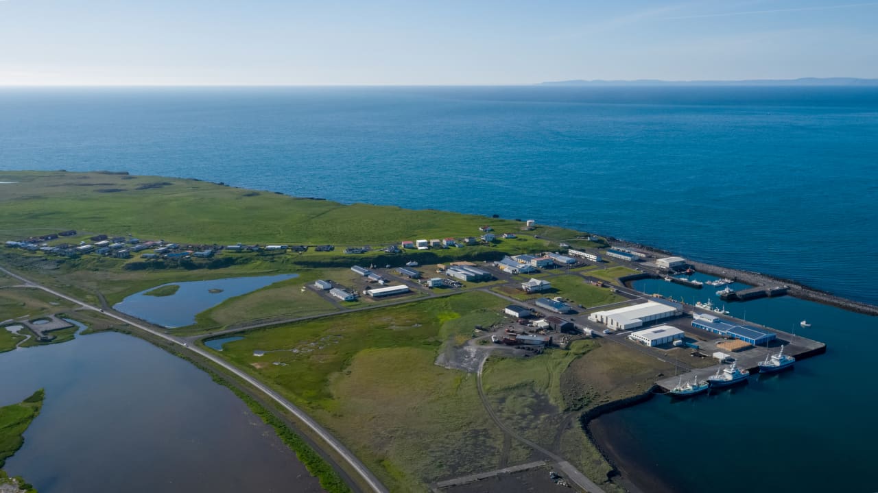 Aerial view of Rif harbor, fishing boats, and the low village edge on the north side of Snæfellsnes.