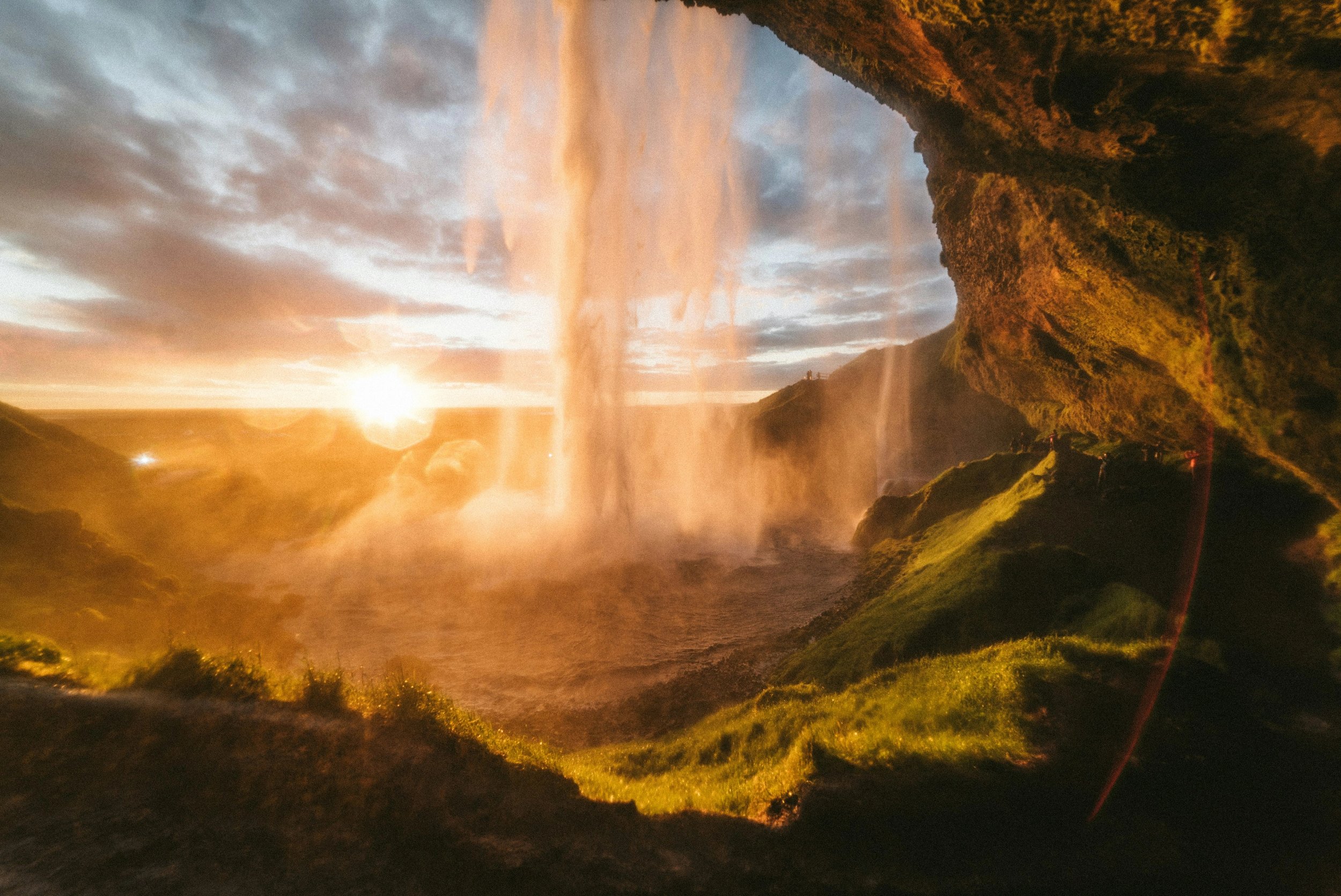 Sunset light seen through the falling water from behind Seljalandsfoss.