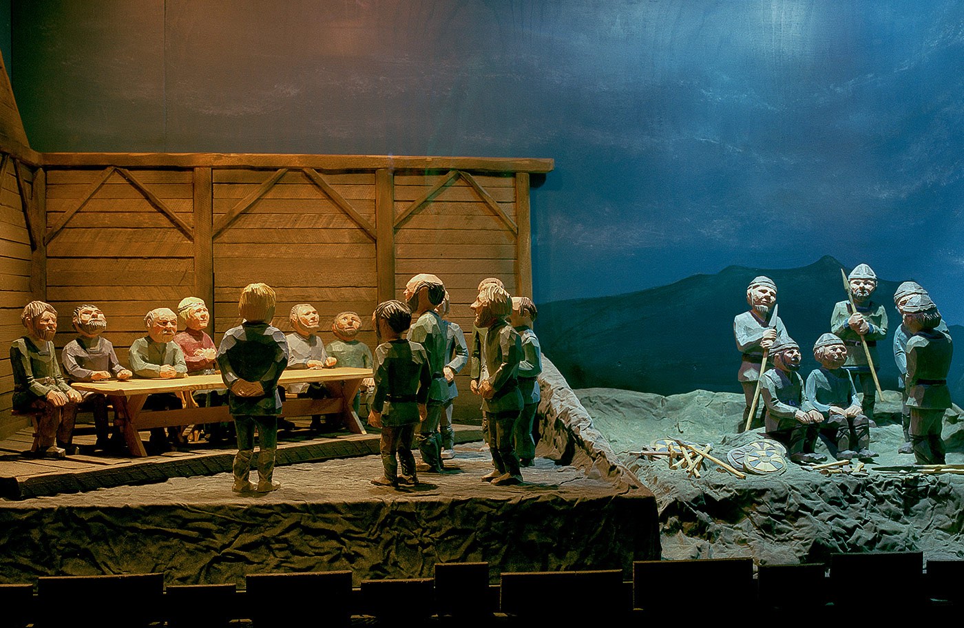 Carved figures in the Settlement Center exhibition showing early Icelandic settlers around a table.