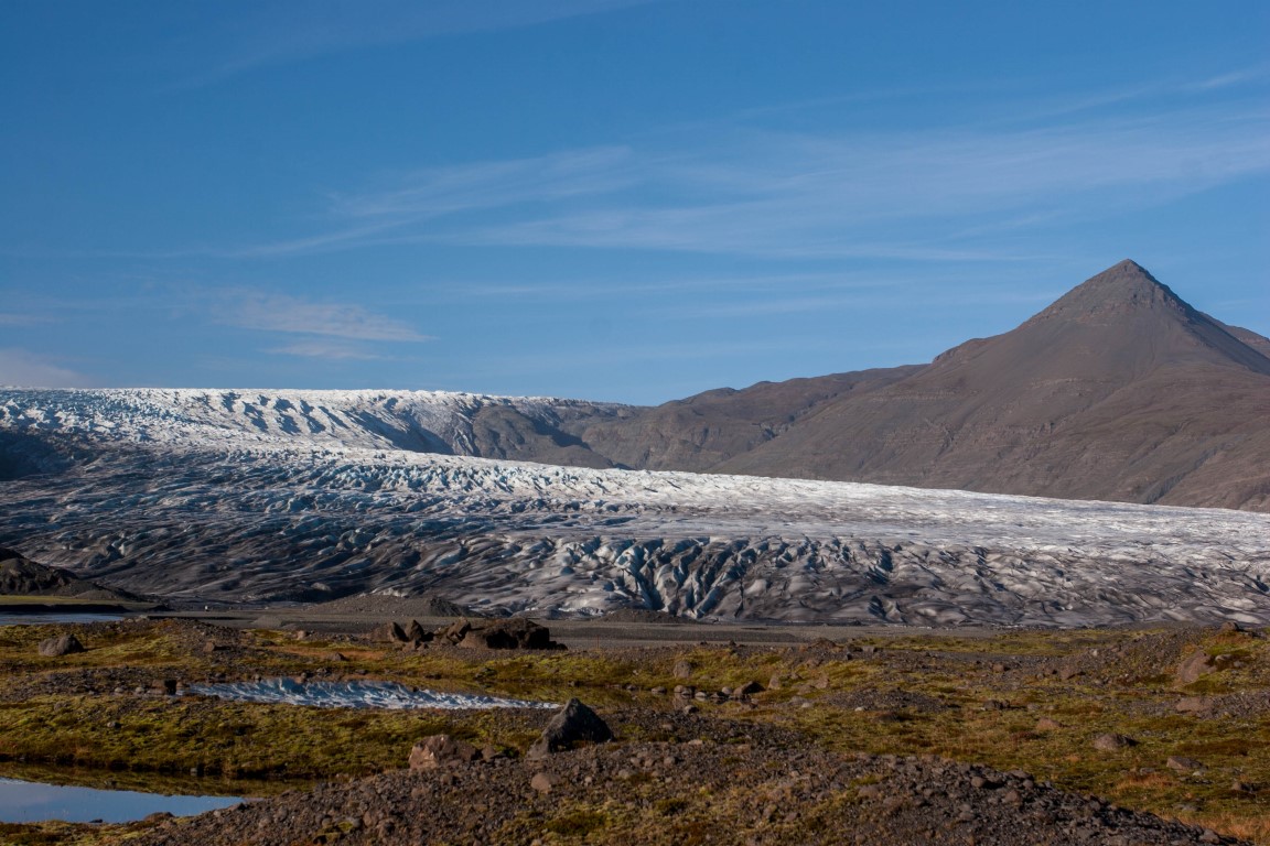 Skálafellsjökull glacier beyond dark moraine and mountain slopes near Skálafell.