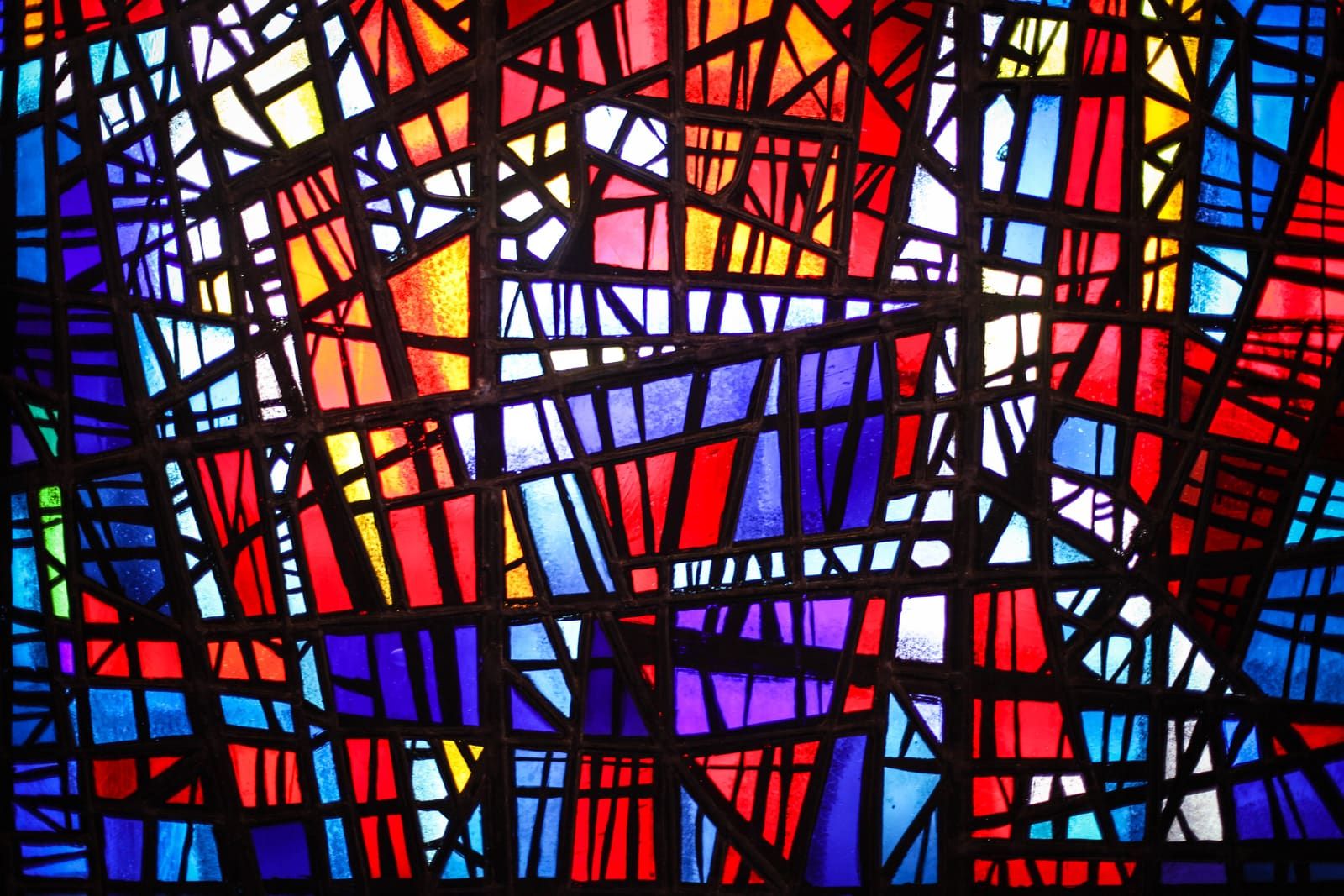 Close detail of colorful stained glass inside Skálholt Cathedral.