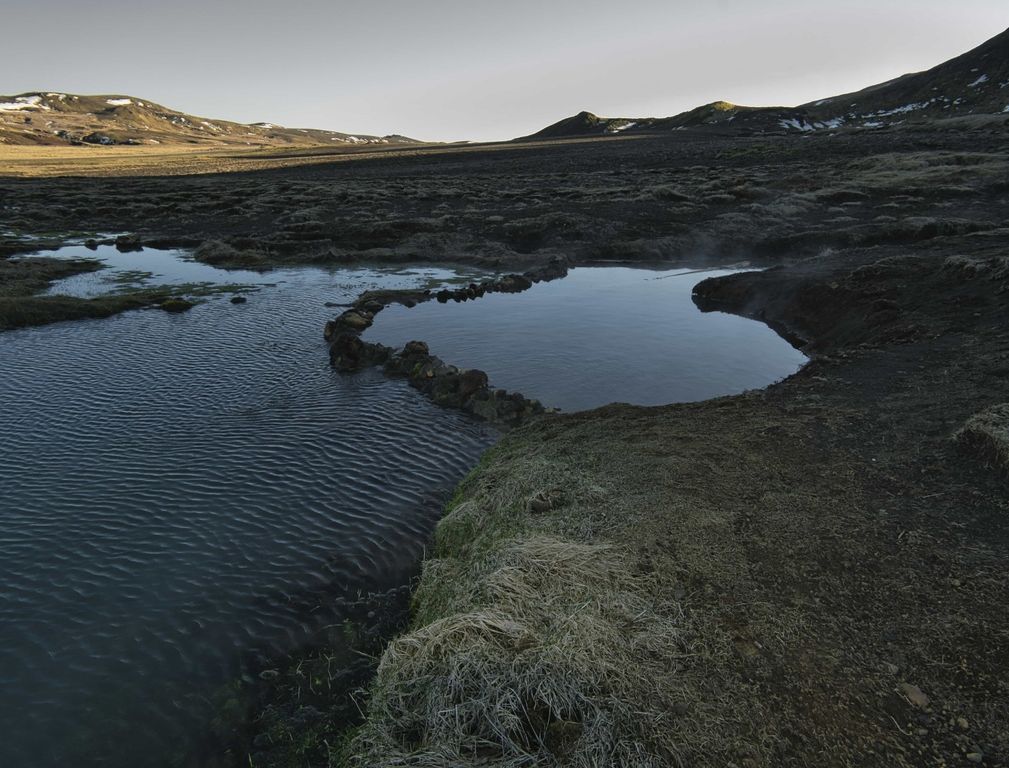 The connected natural pools of Skátalaug Hot Spring in open Reykjanes terrain.