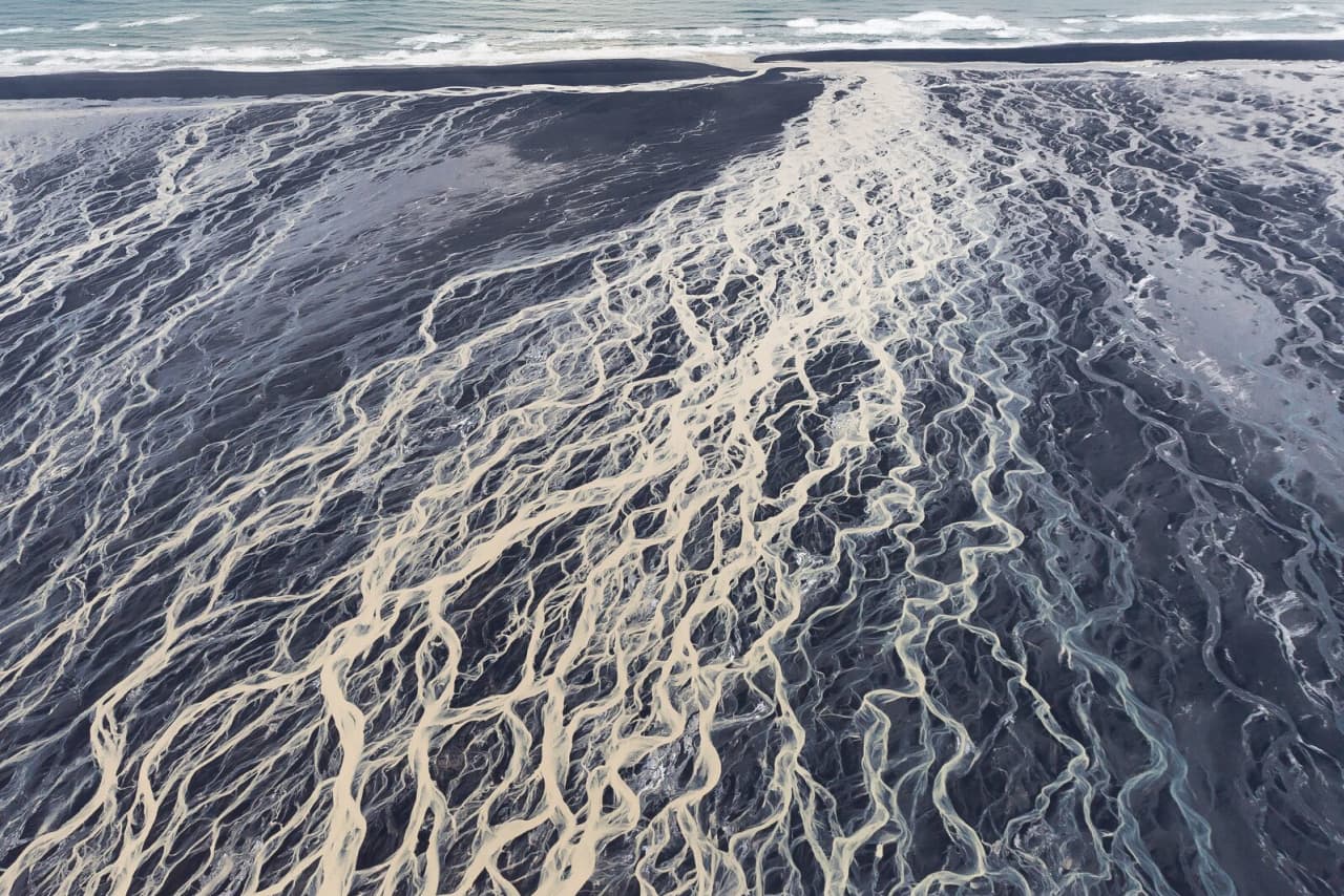 Braided glacial rivers crossing the black sand of Skeiðarársandur before reaching the Atlantic.